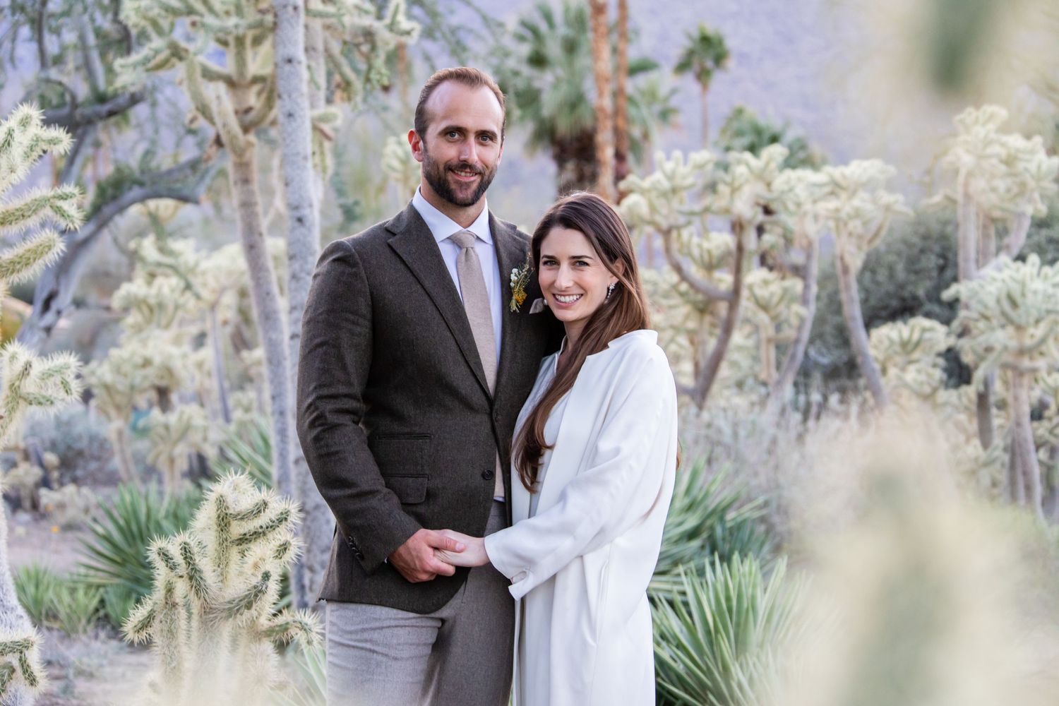 Romantic desert wedding photos among native plants and cacti.