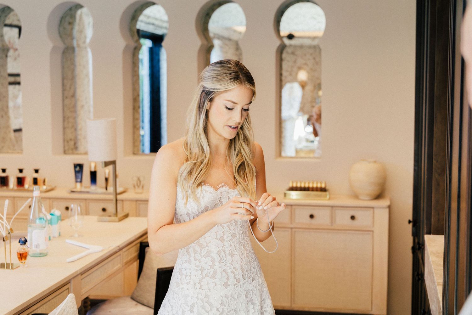 Elegant bridal suite with arched windows and natural lighting.