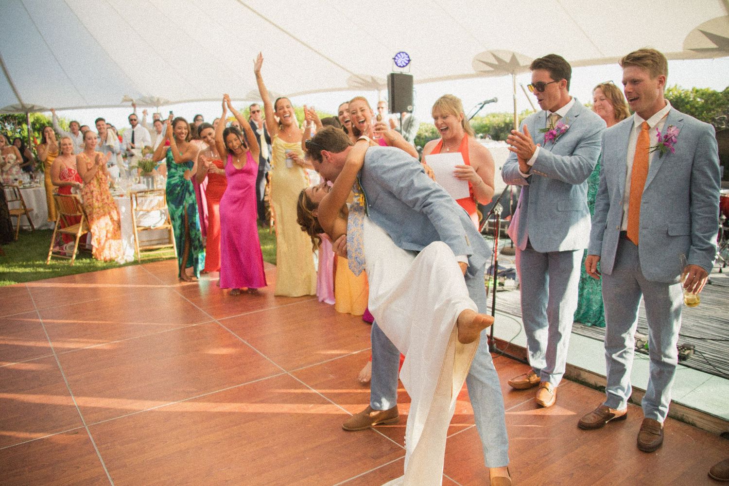 Celebratory dance moment during outdoor wedding reception.