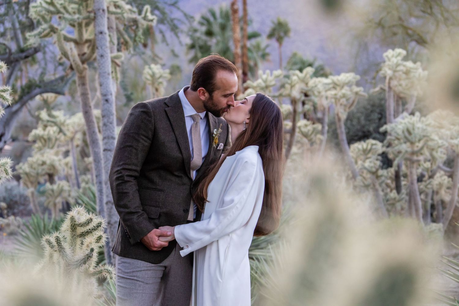 Candid wedding moments photographed in a natural desert setting.