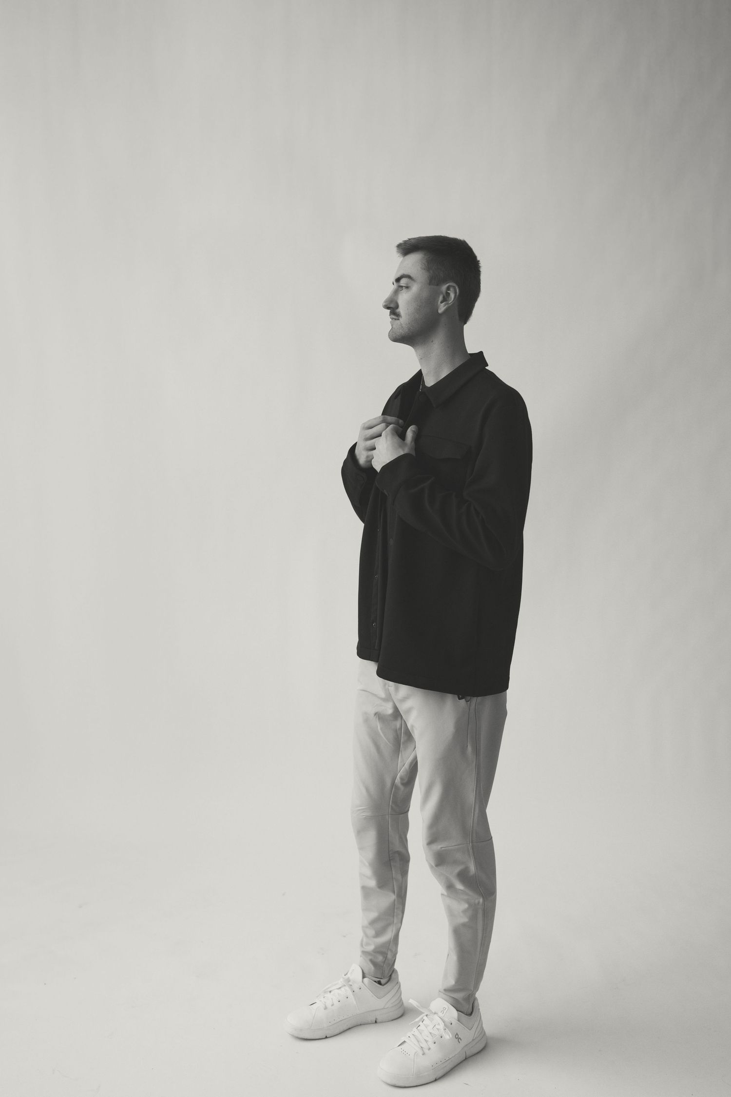 Stylish monochrome portraits showing casual poses against white backdrop.