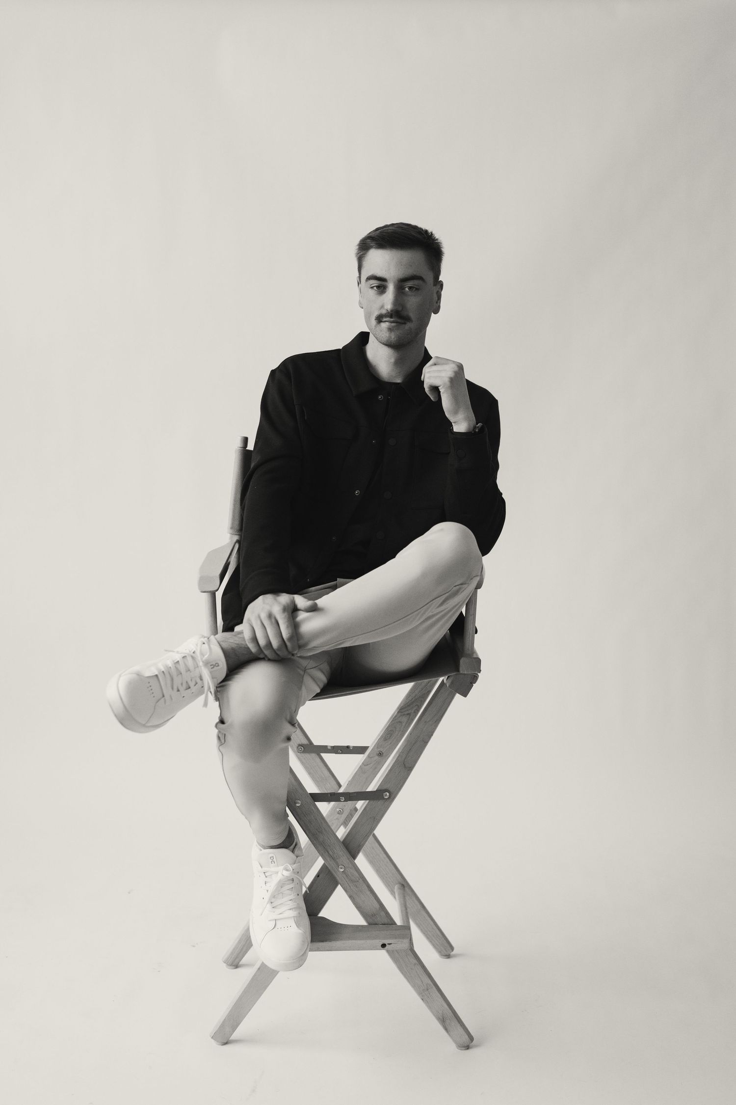 Artistic black and white portraits showing seated poses on director's chair.