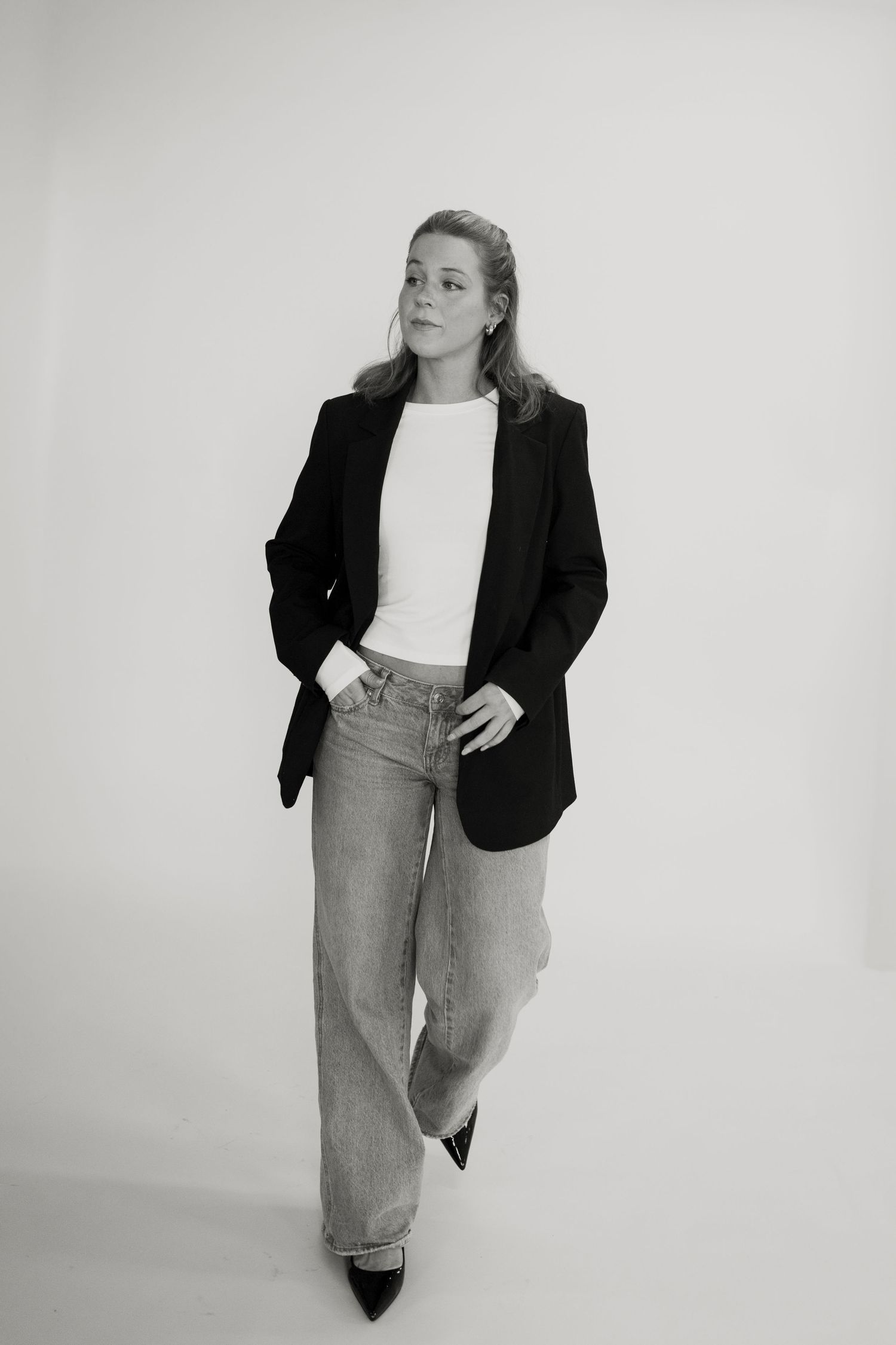 Professional look featuring black blazer and wide-leg jeans in black and white.