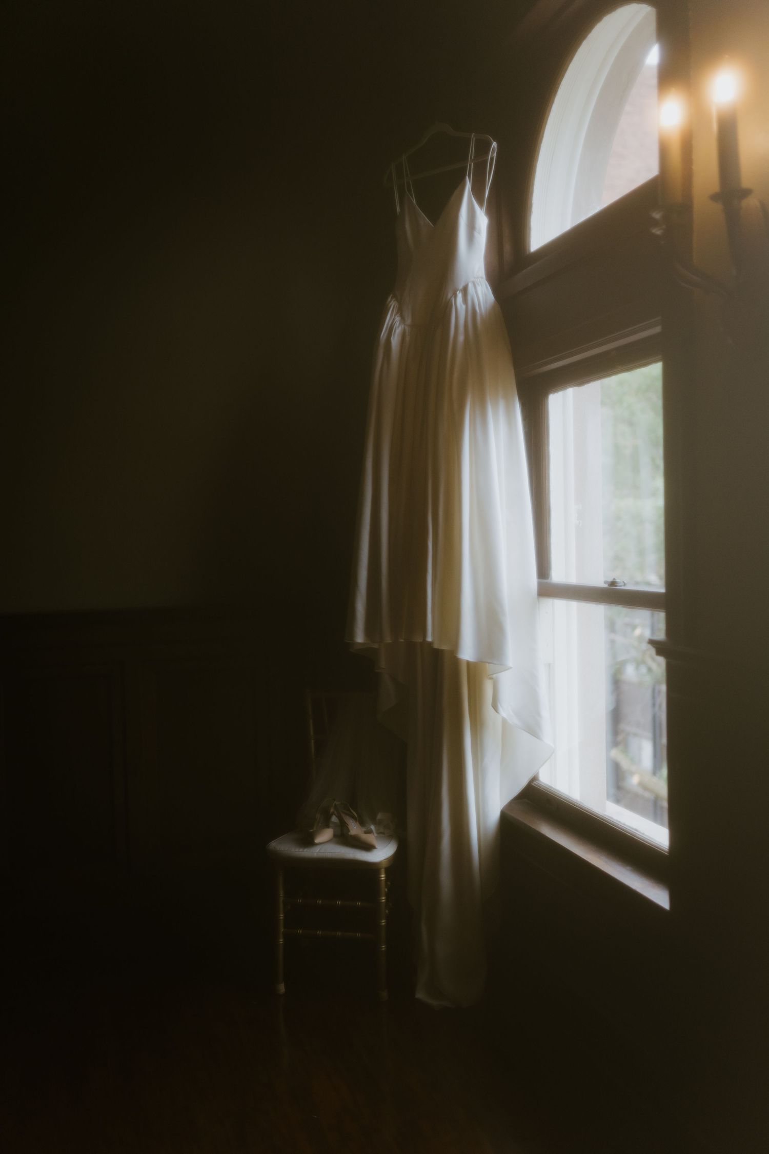 Atmospheric window scene with soft natural light filtering through sheer curtains.