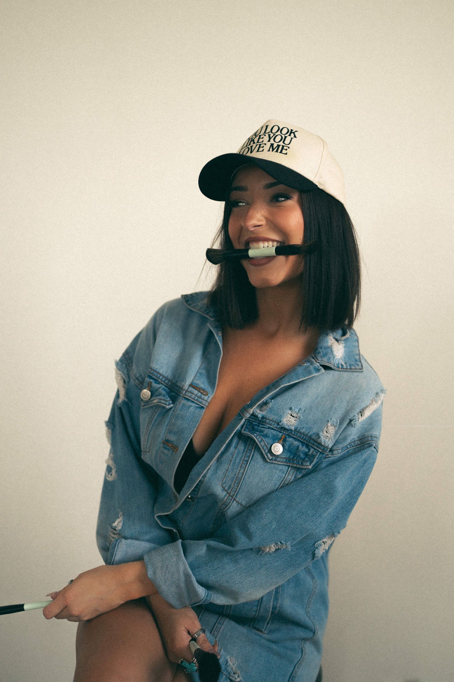 Fashion portraits featuring denim jacket and baseball cap styling.