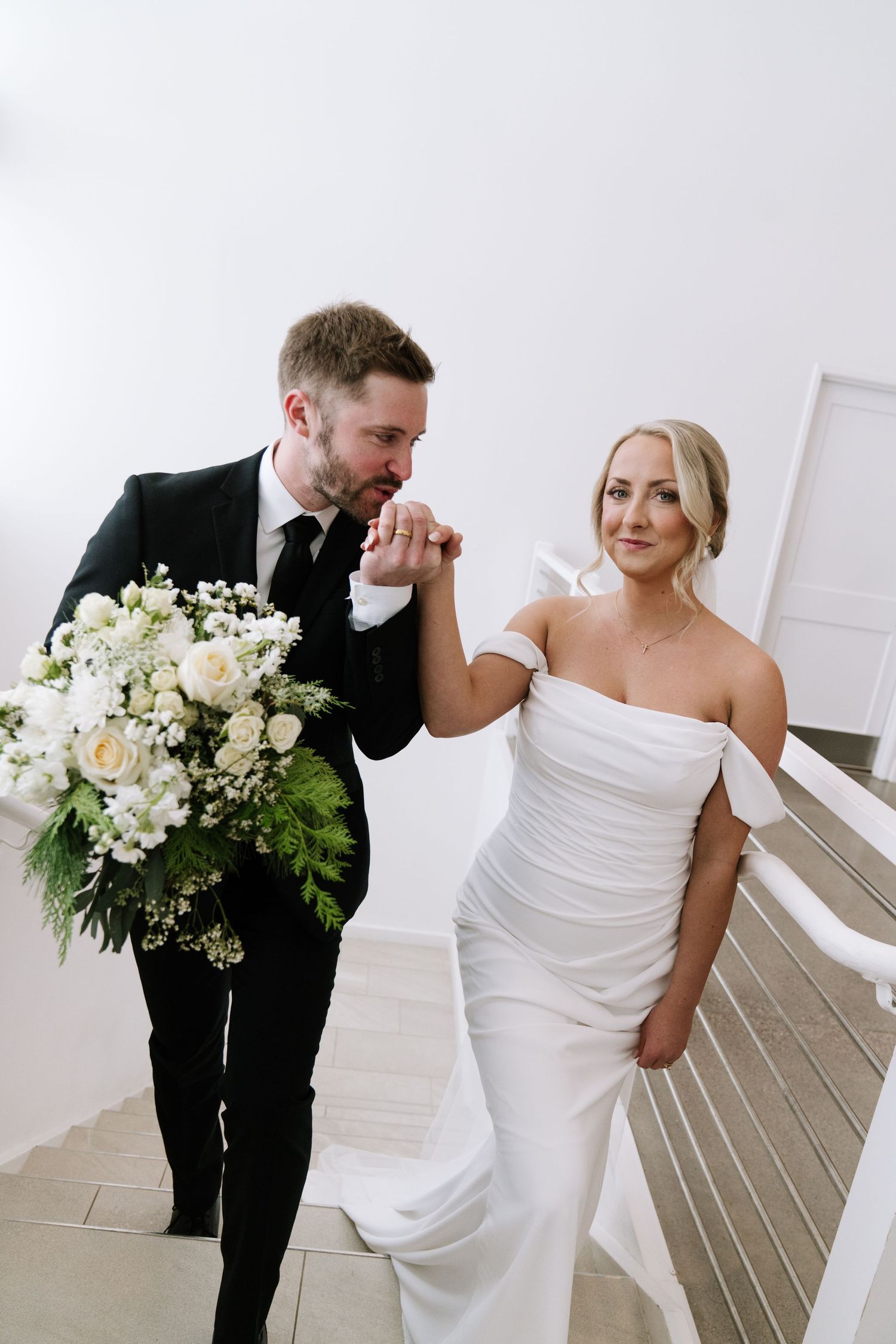 Emotional first look moment between newlyweds in a bright modern space.