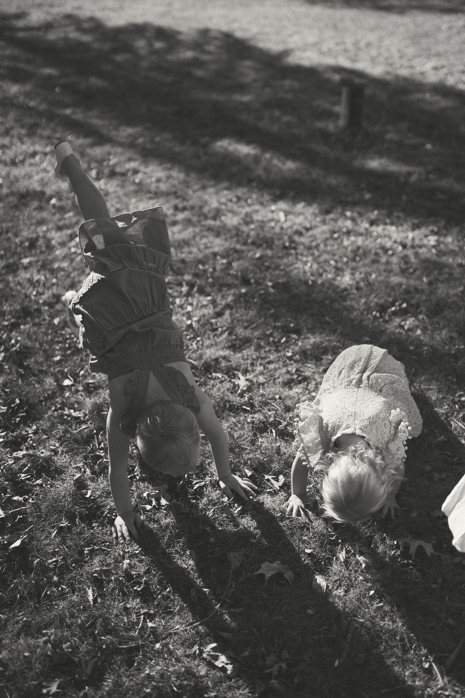 Black and white sequence of a person lying in grass creating shadow patterns.