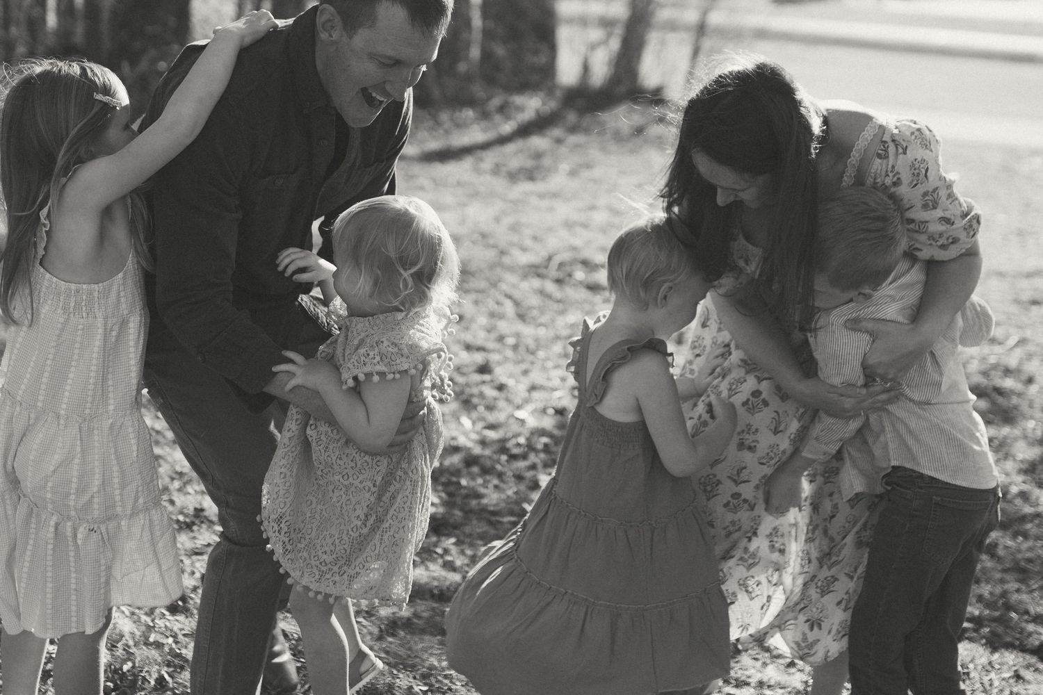 A series of candid moments captured in black and white during a sunny day outdoors.