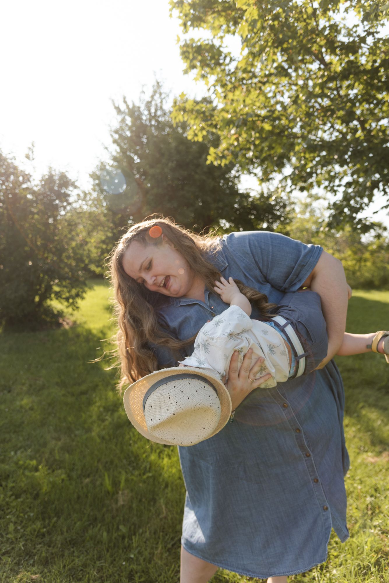 Mother playing with her young son during a candid family photography session in Niagara Falls, Ontario