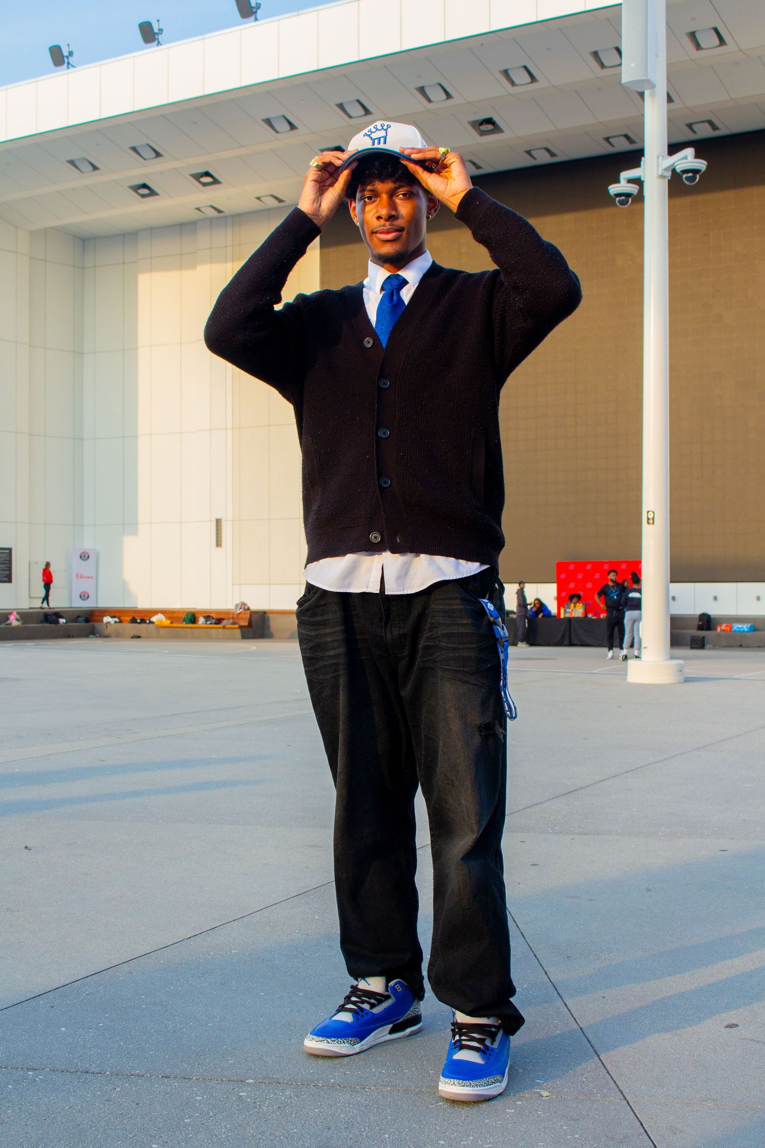 People in business attire standing in a modern empty warehouse space.