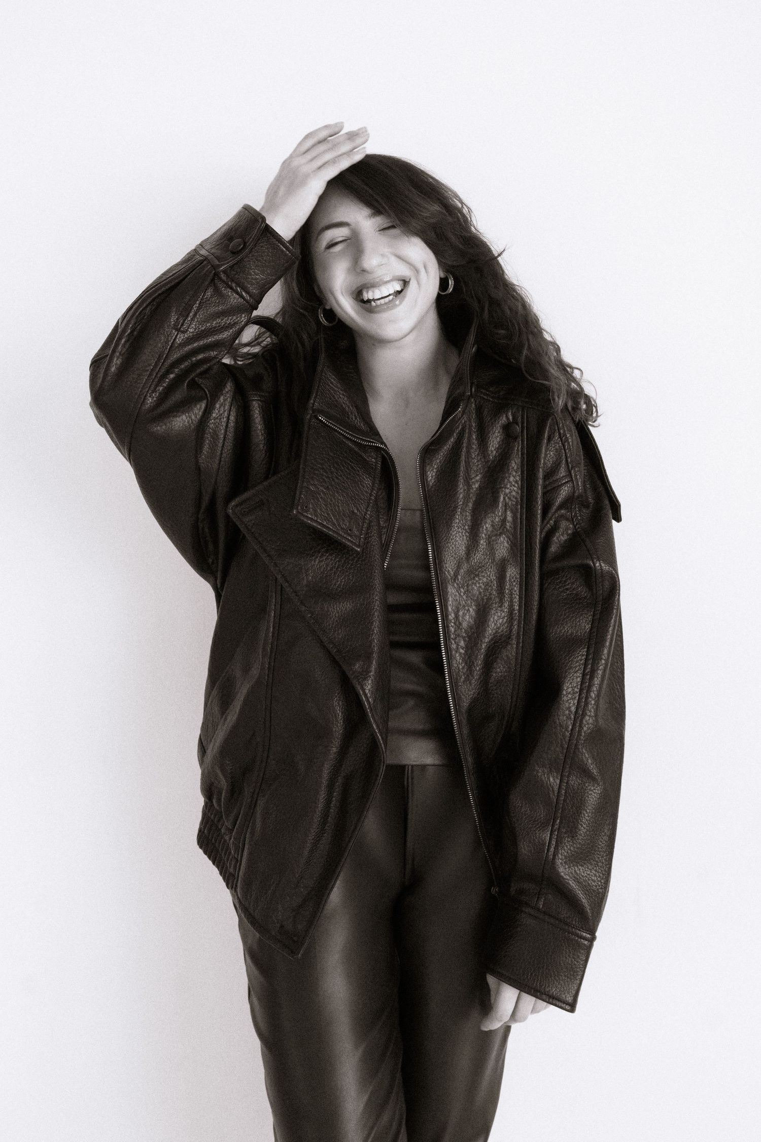 Black and white portrait of Houston photographer Nika Alikhan in leather jacket