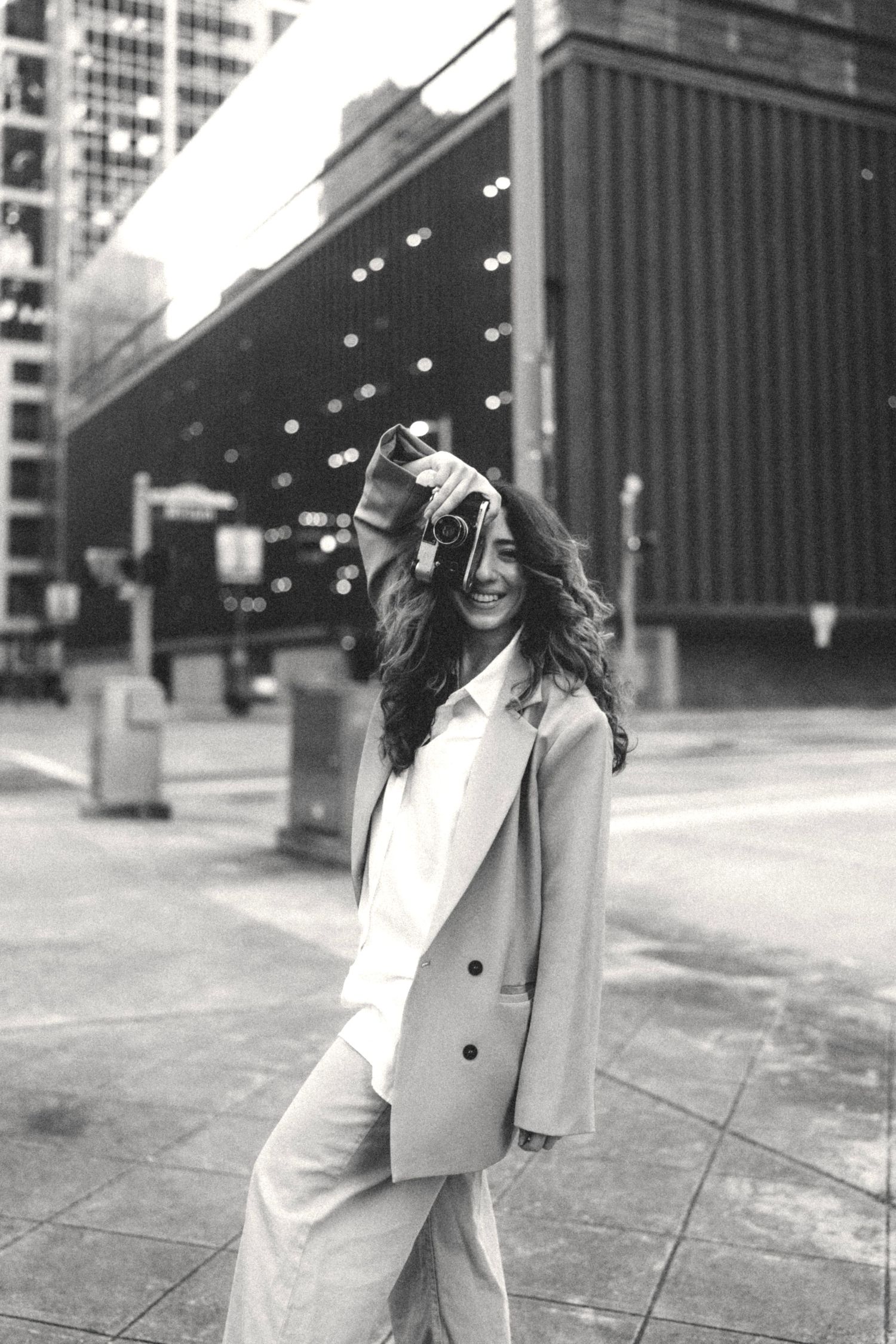 Houston photographer Nika Alikhan walking in downtown Houston wearing blazer