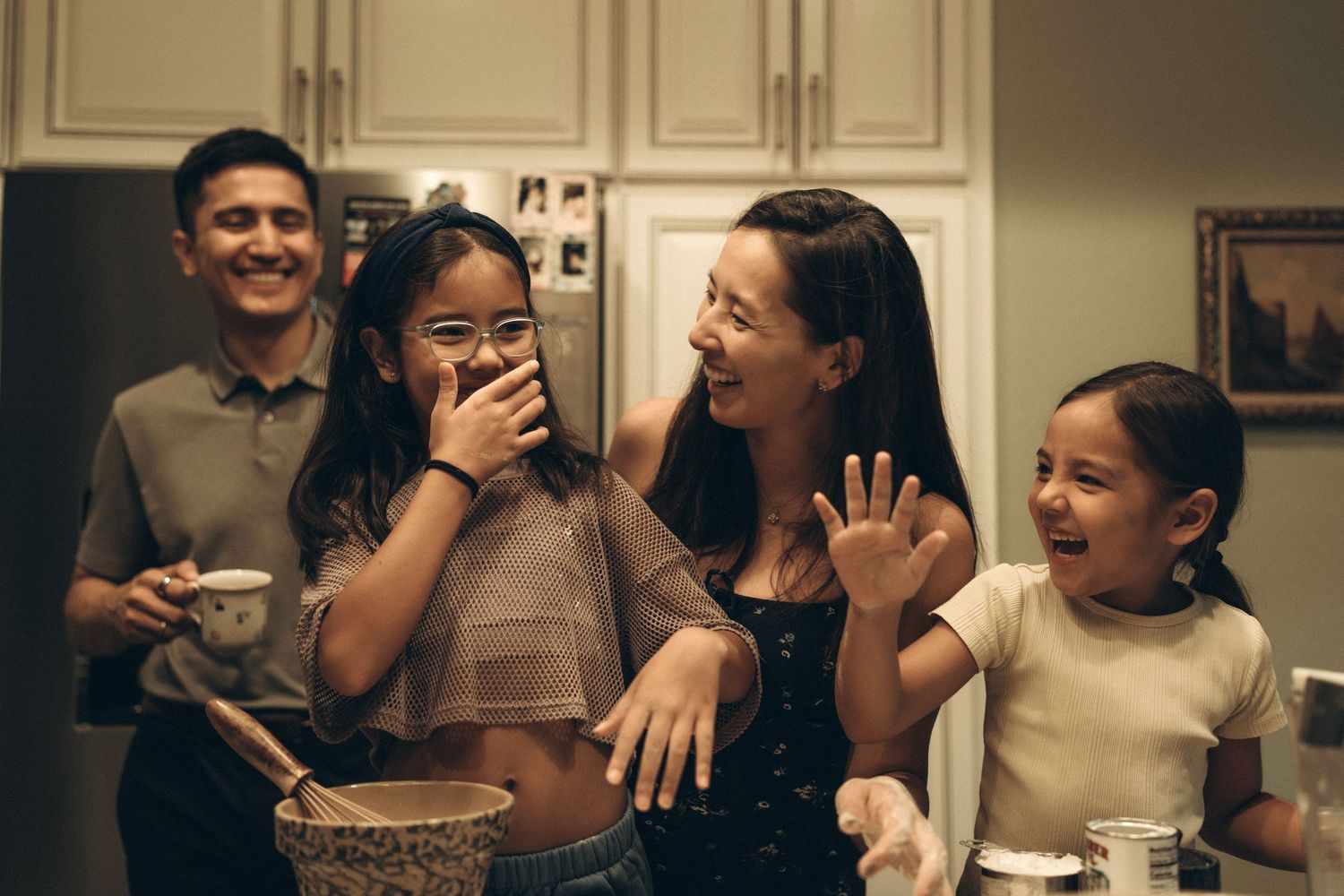 Family laughing together in kitchen lifestyle session Houston photographer