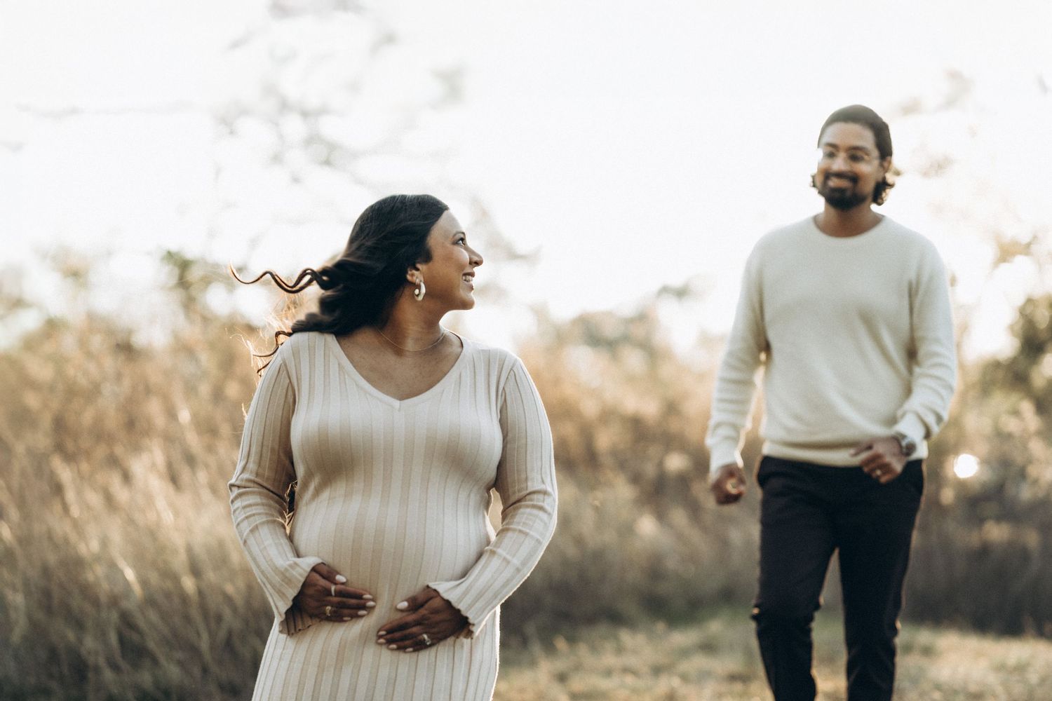 Maternity session in nature with couple walking together Houston photographer