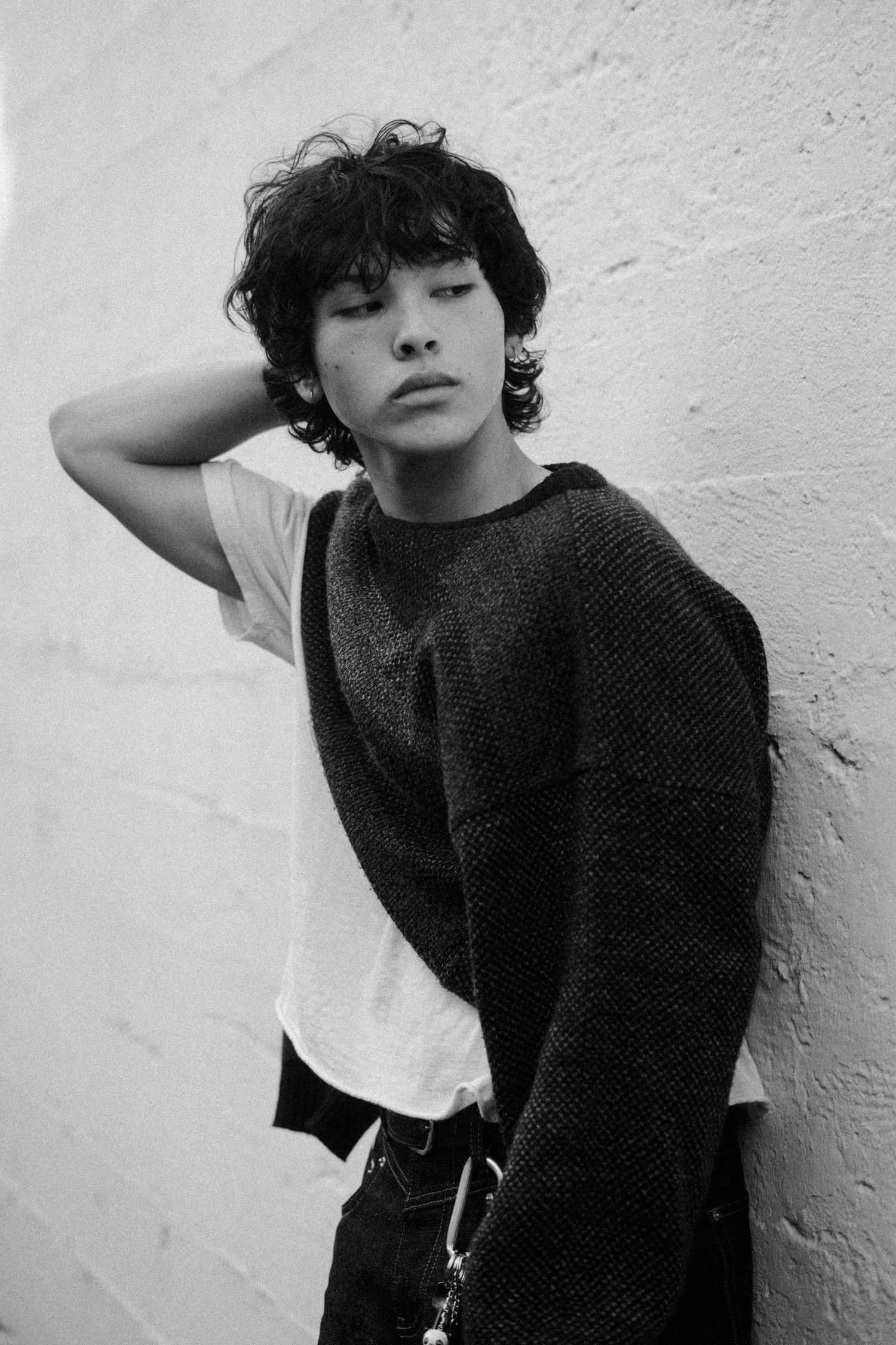 Dramatic fashion portrait series showing casual style against white wall.