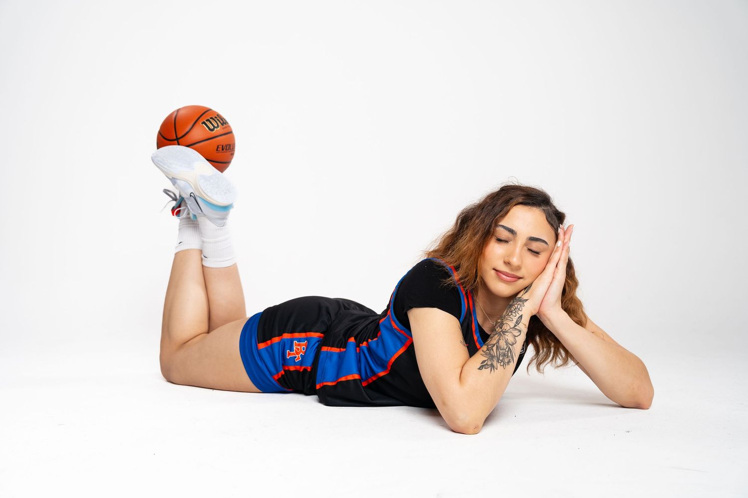 Athletic person in sportswear and red headband lying on white background in various relaxed poses.