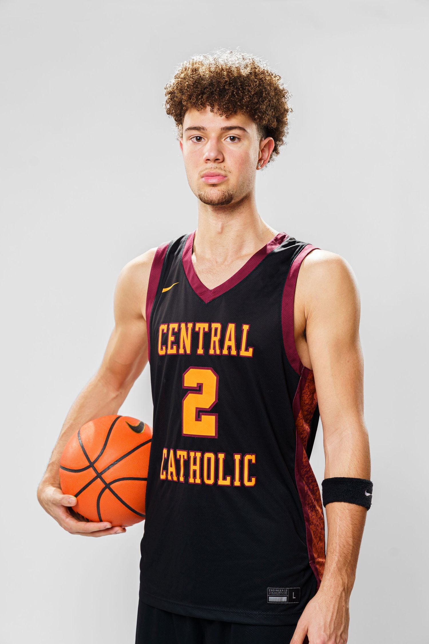 Basketball player poses with ball wearing black Central Catholic jersey number 2.