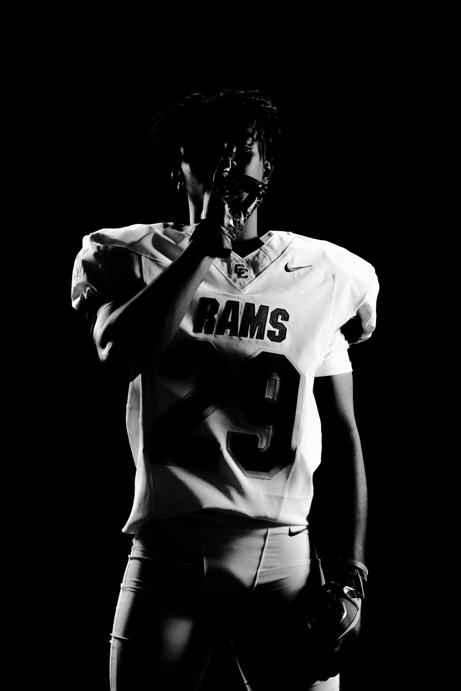Black and white photo of a football player in a Rams number 9 jersey posing dramatically against a dark background.