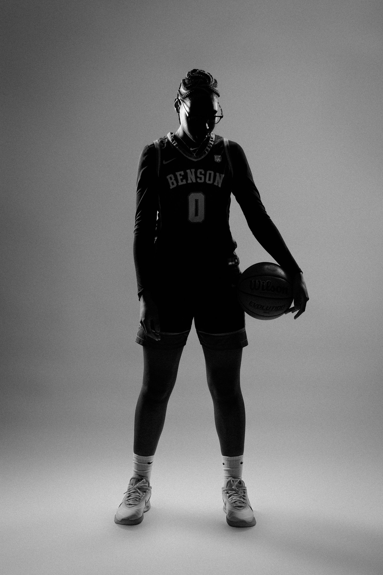 Dramatic black and white silhouette of an athlete in uniform.