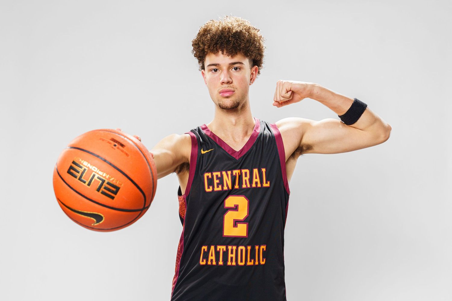 Basketball player in Central Catholic jersey performs action poses with ball.