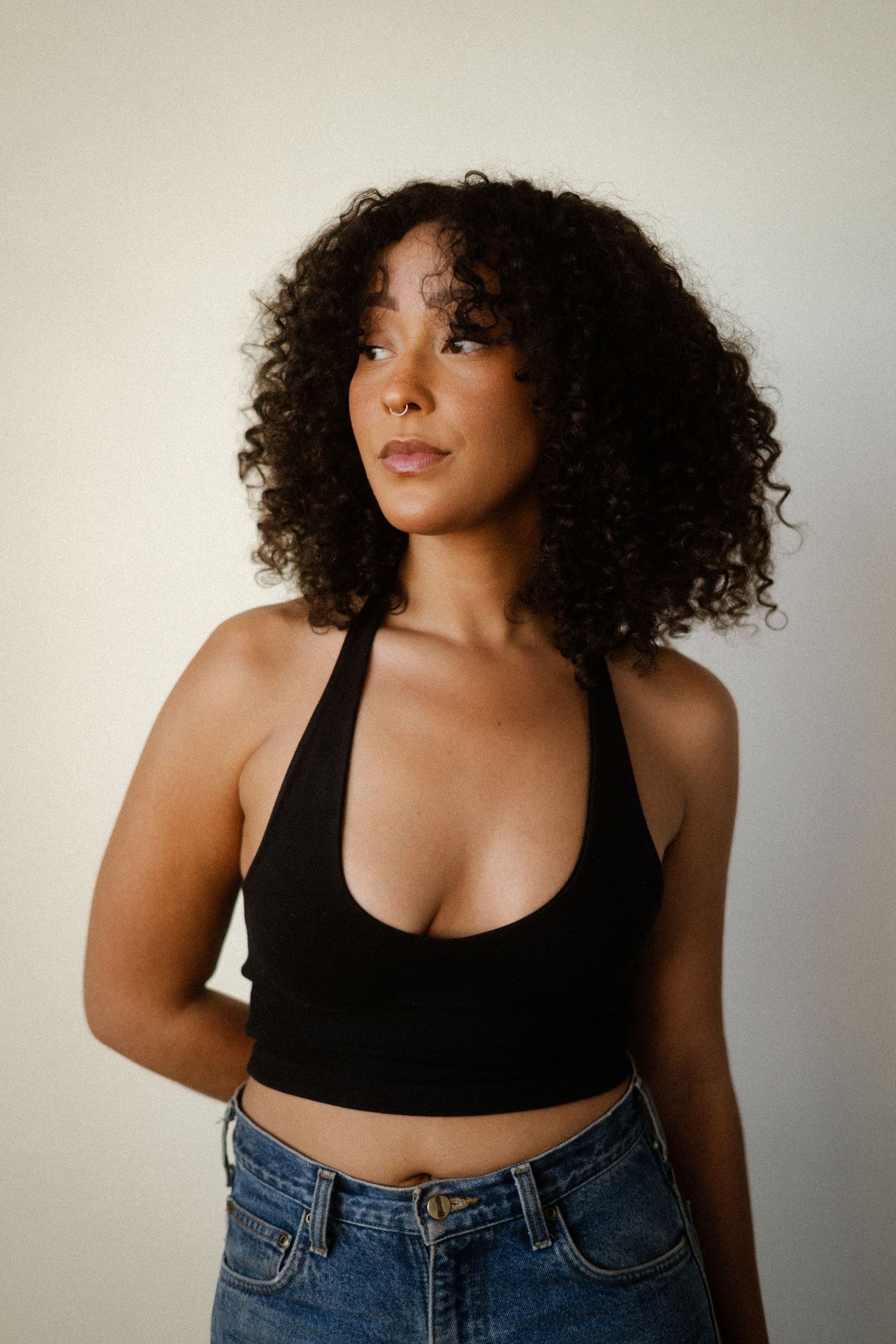 Fashion portrait series showing casual style with black top and denim.