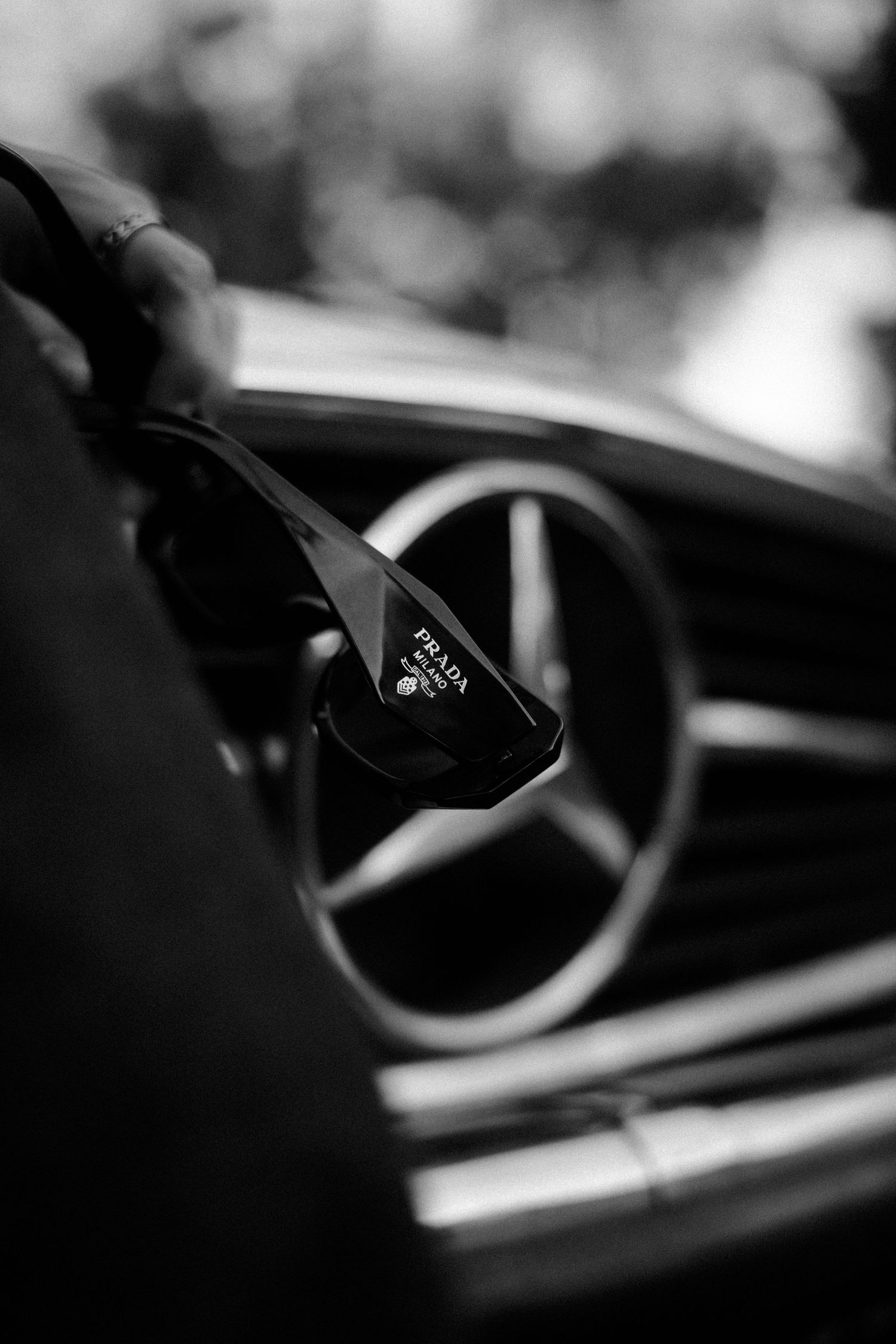 Artistic black and white shot of a Mercedes-Benz steering wheel interior.