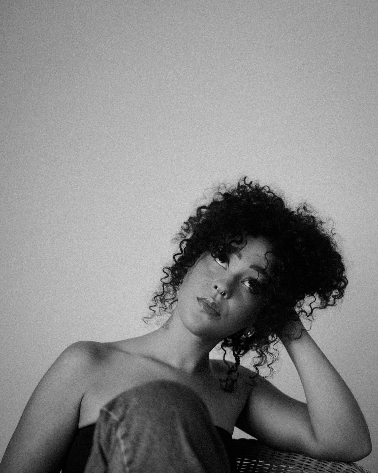 Black and white artistic portrait sequence showing dramatic poses with natural curls.
