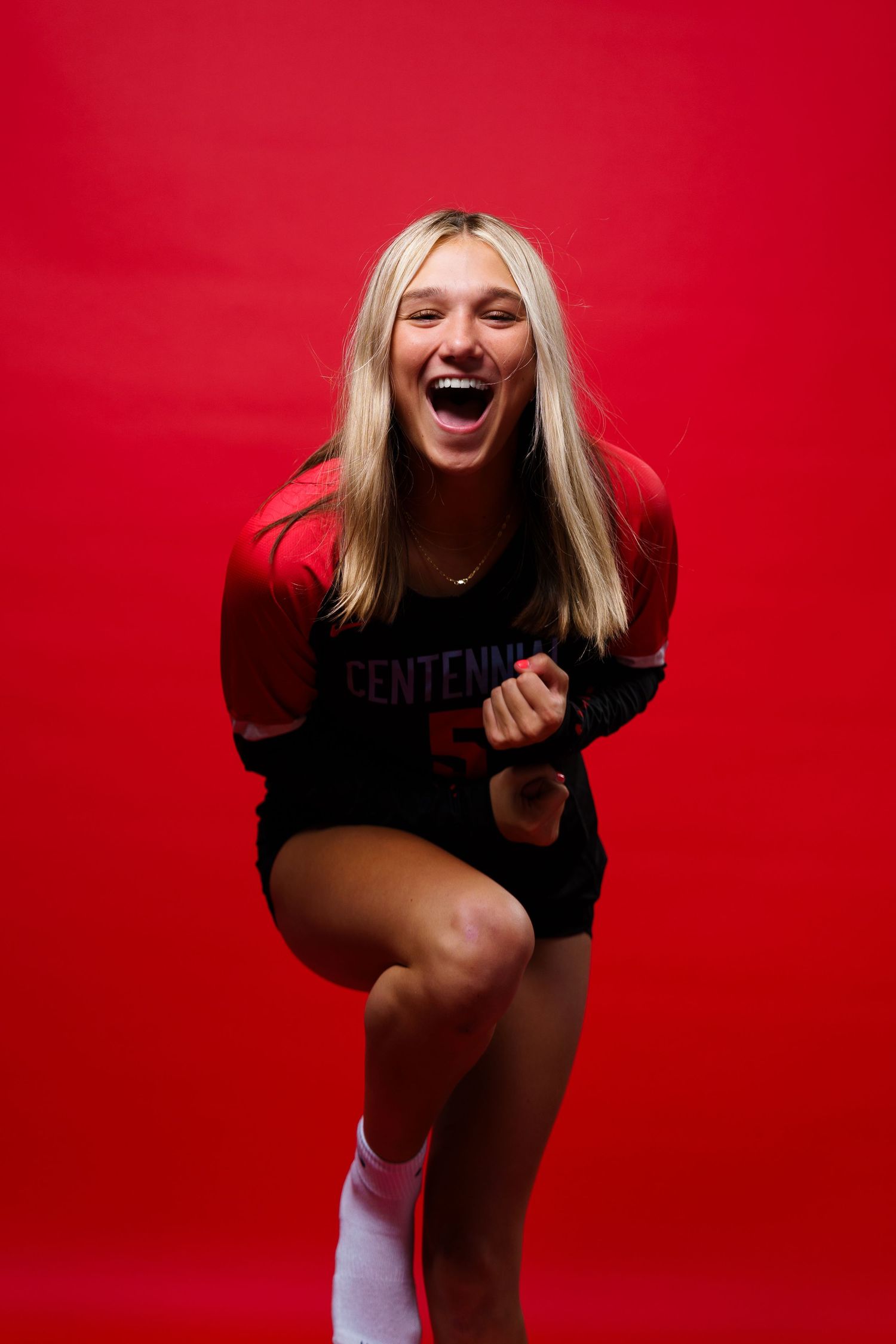 A series of dynamic portrait shots against a vibrant red background showing joyful expressions and movement.