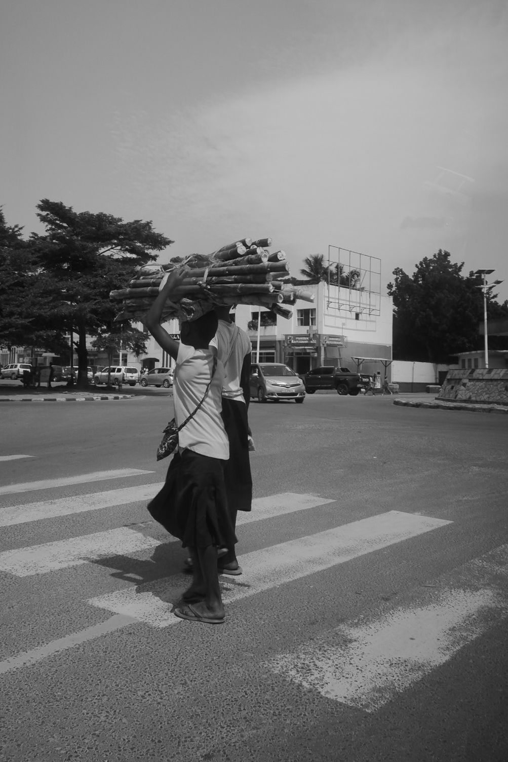 People crossing street at zebra crossing in urban setting.