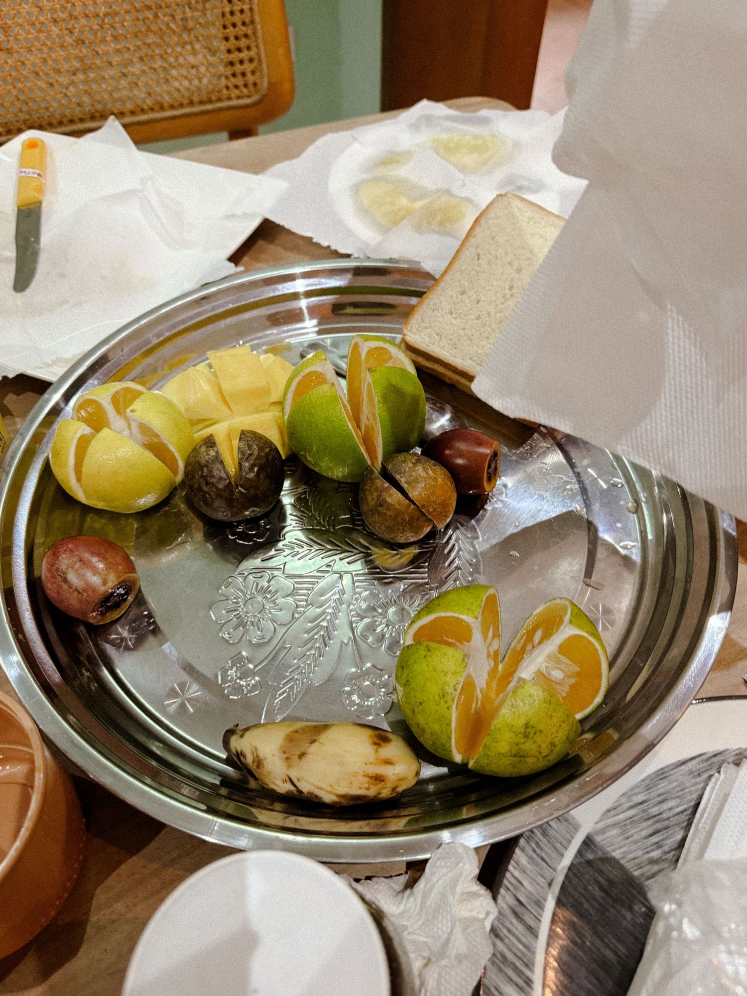 Fresh citrus fruits and garnishes arranged on elegant glass serving plates.
