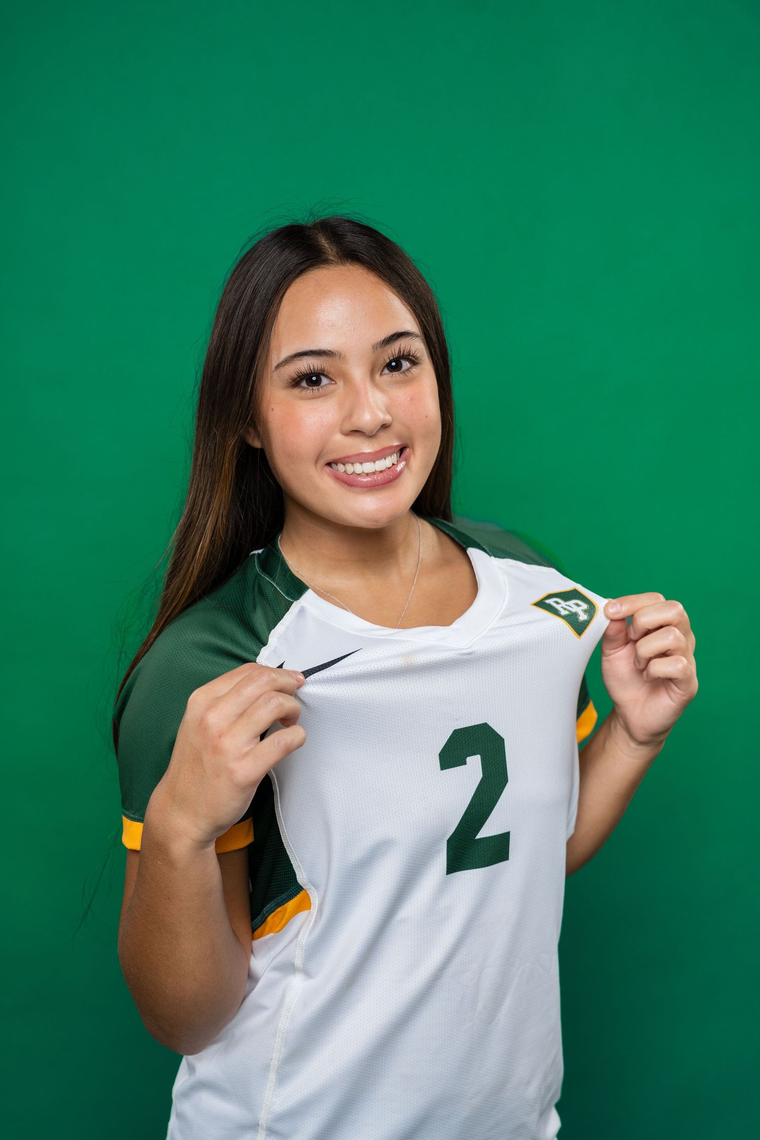 Person wearing white jersey with number 2 poses against green background showing different angles of the uniform.