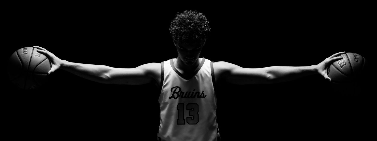 Artistic black and white panoramic portrait of basketball player silhouettes.