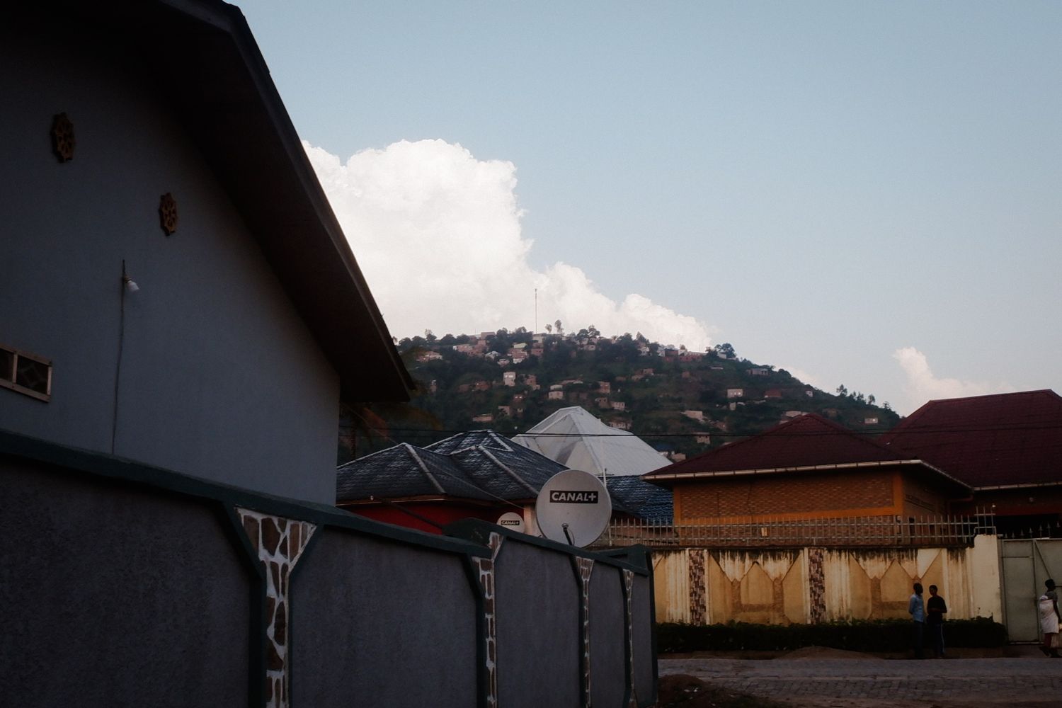 Row of houses with similar architecture against a bright blue sky.