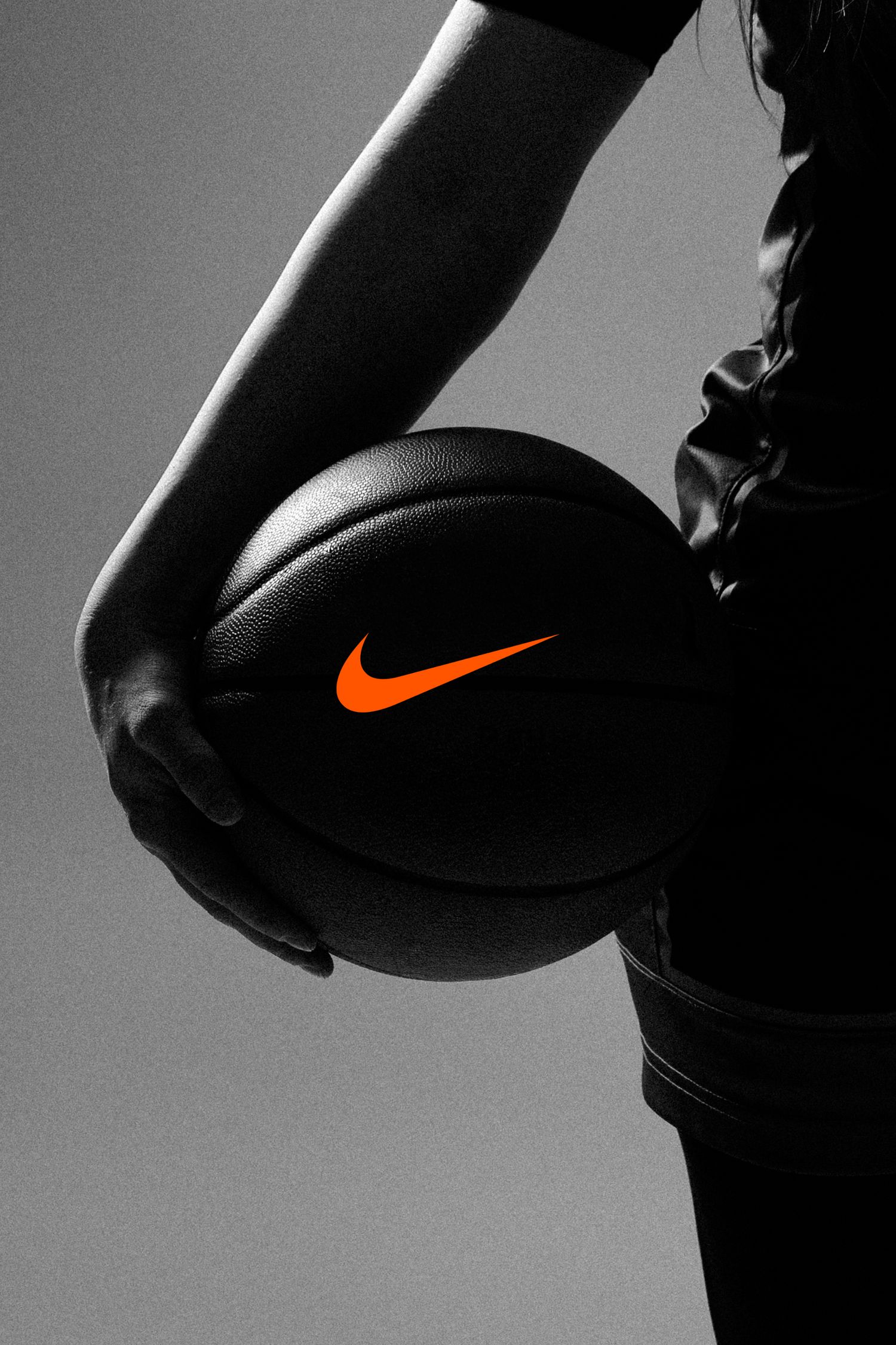 Black and white photo series showing a Nike basketball with orange swoosh logo in dramatic lighting.