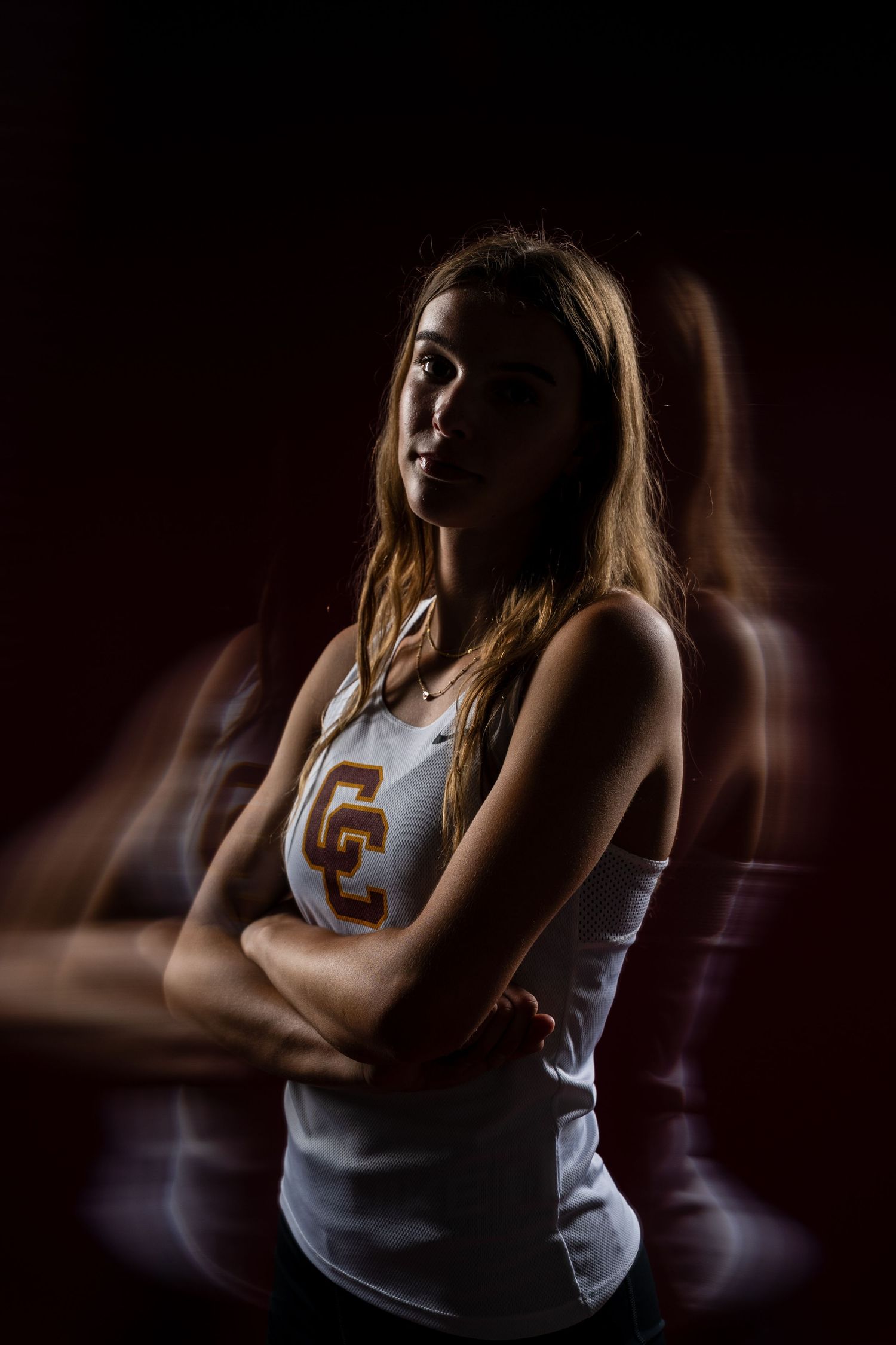 Artistic silhouette portraits of athlete in white jersey against dark background.