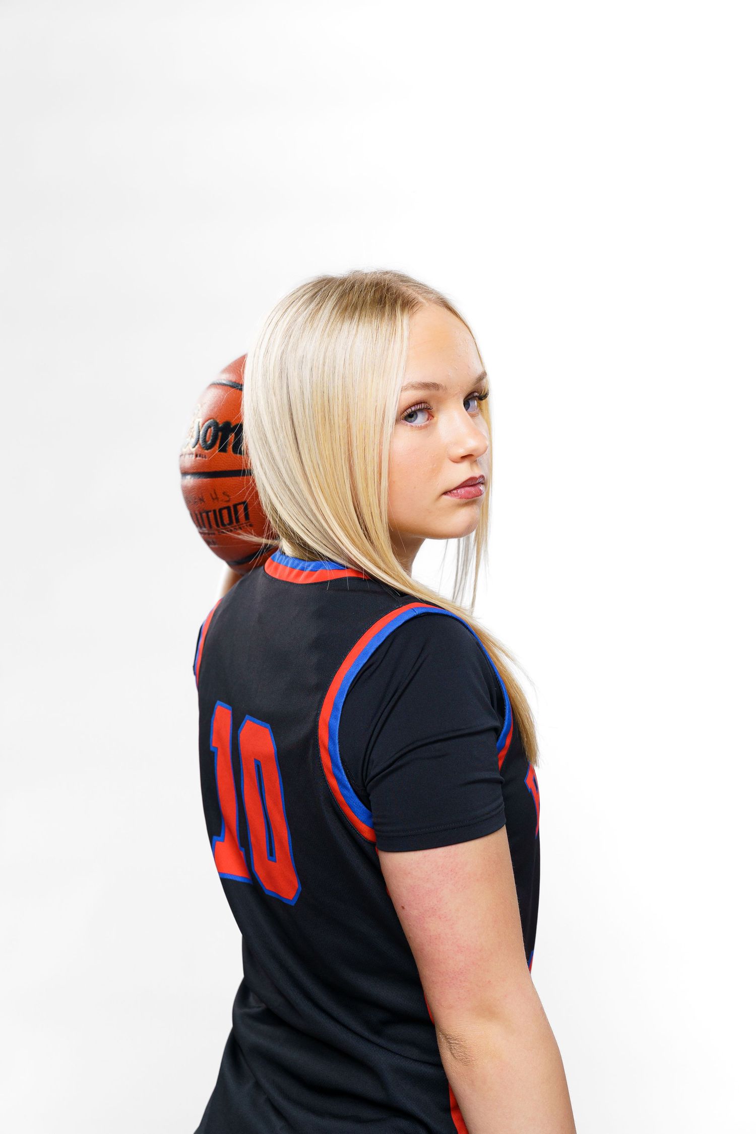 Basketball player wearing navy jersey shown in profile sequence with ball.