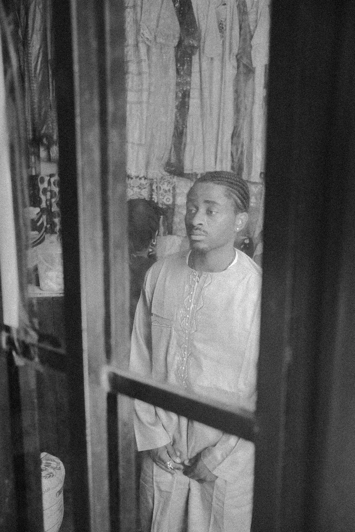 Artistic black and white photograph showing multiple reflections in window glass.