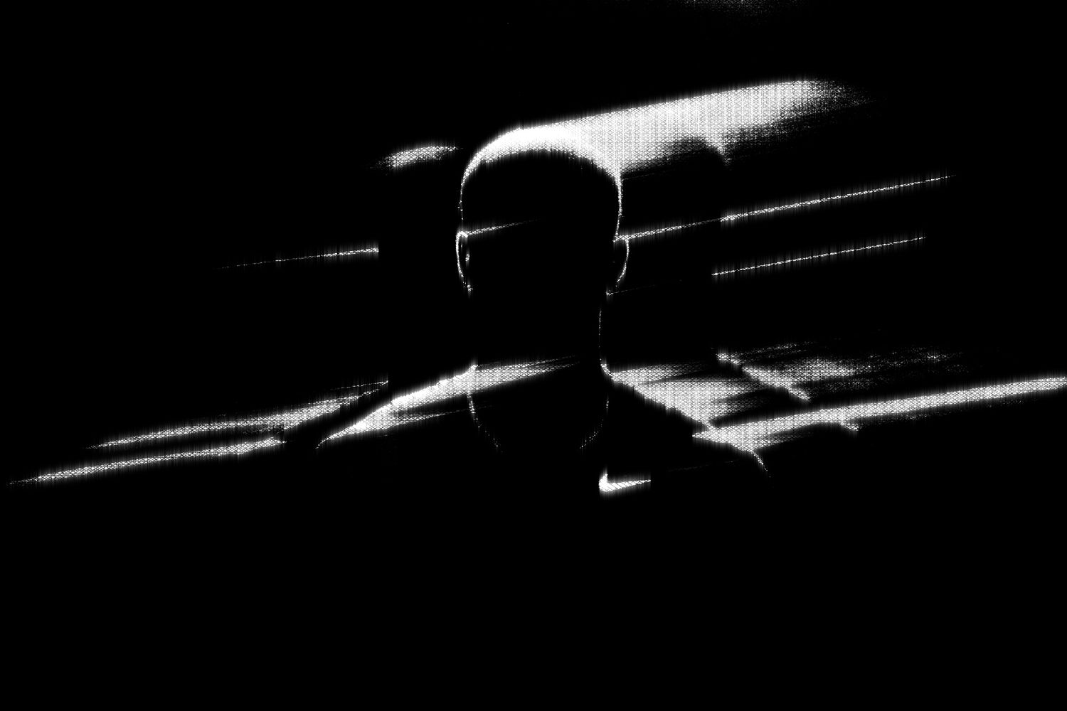 Dramatic black and white silhouette of basketball player in motion.