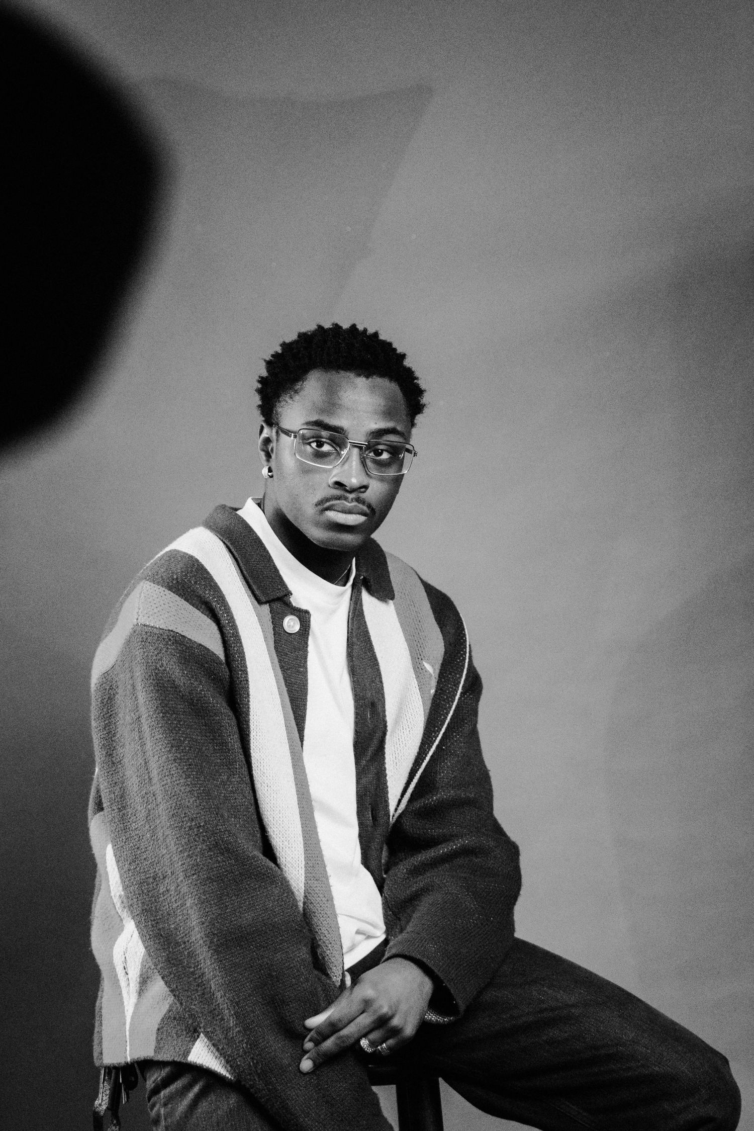 Portrait series in black and white showing person in striped sweater.