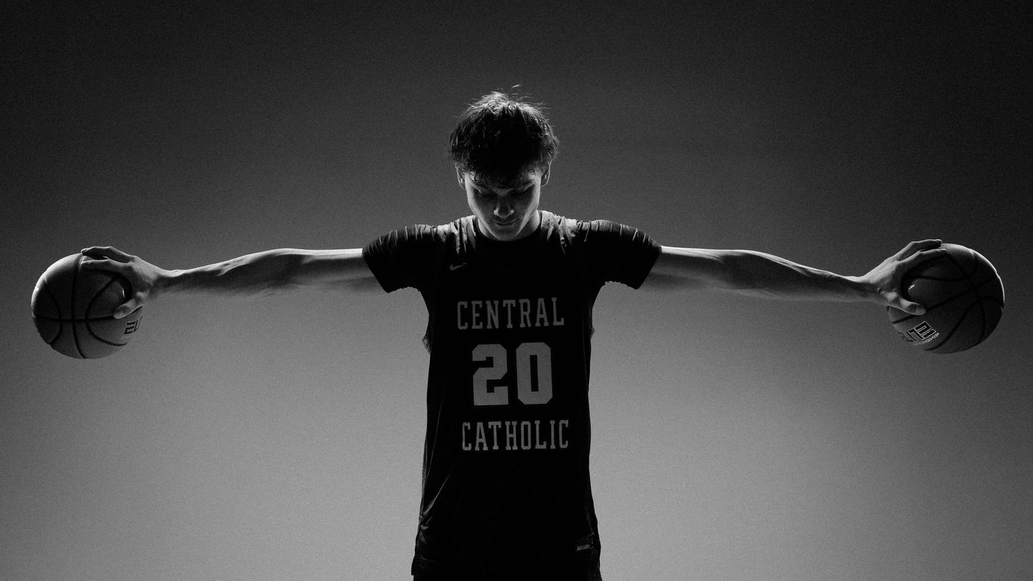 Basketball player in Central Catholic uniform shown in dramatic panoramic silhouette.