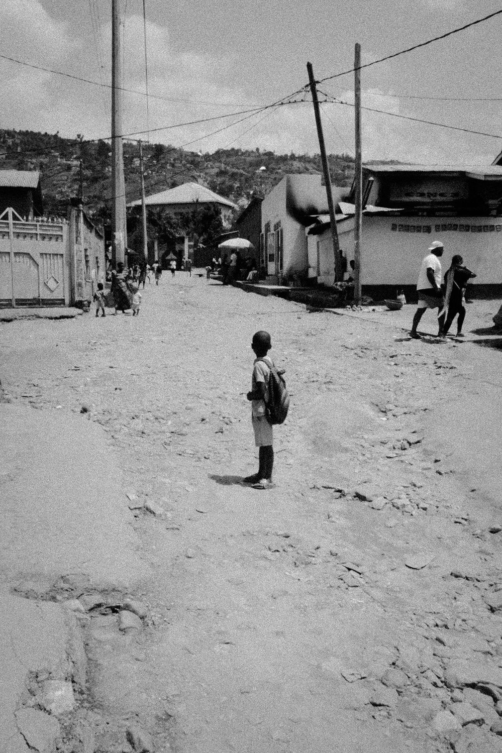 Black and white panorama of a rural village with scattered buildings and power lines.