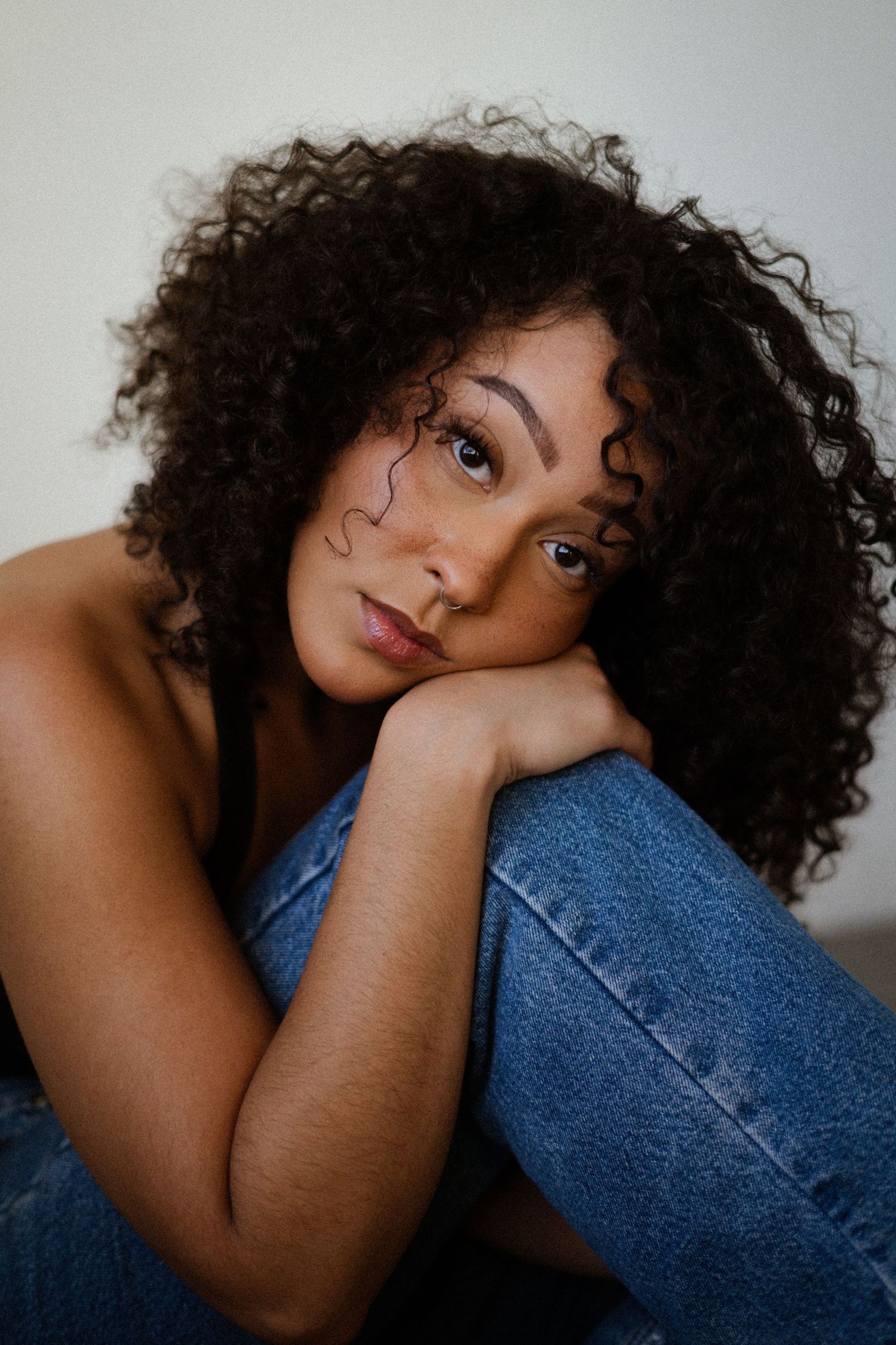 Intimate portraits showing relaxed poses with denim and natural styling.