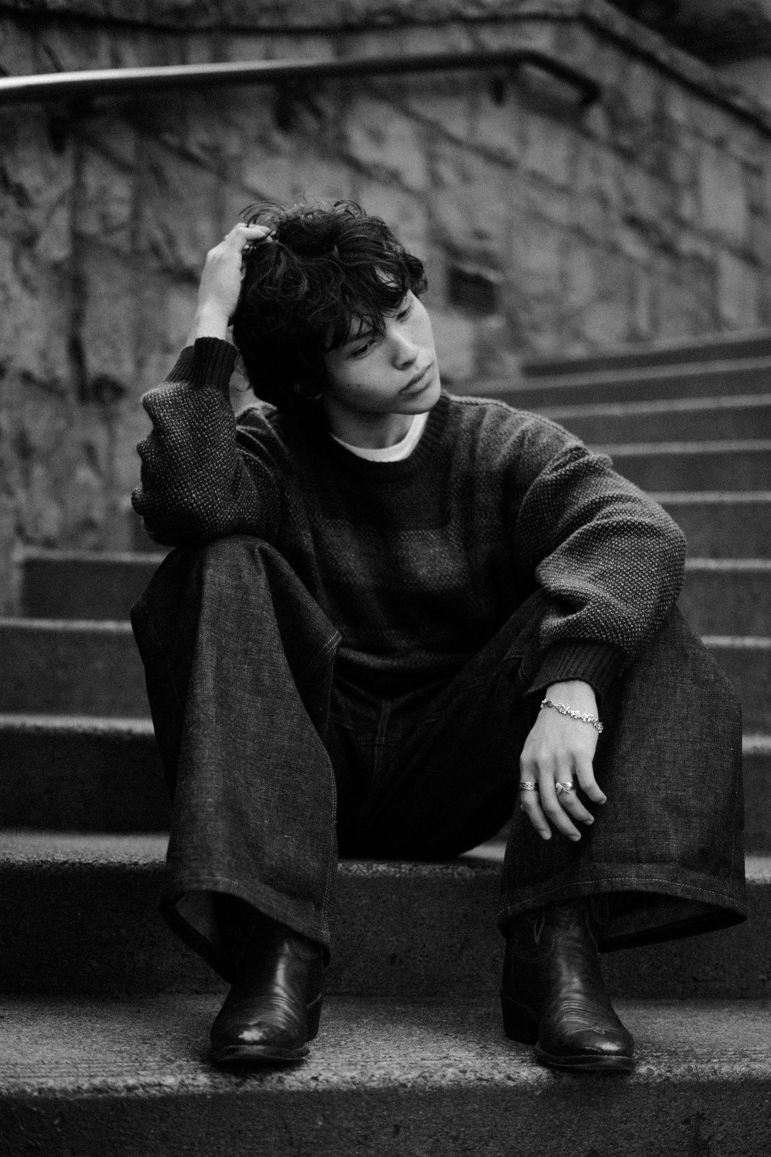Artistic black and white photo on stone steps with dramatic angles and shadows.