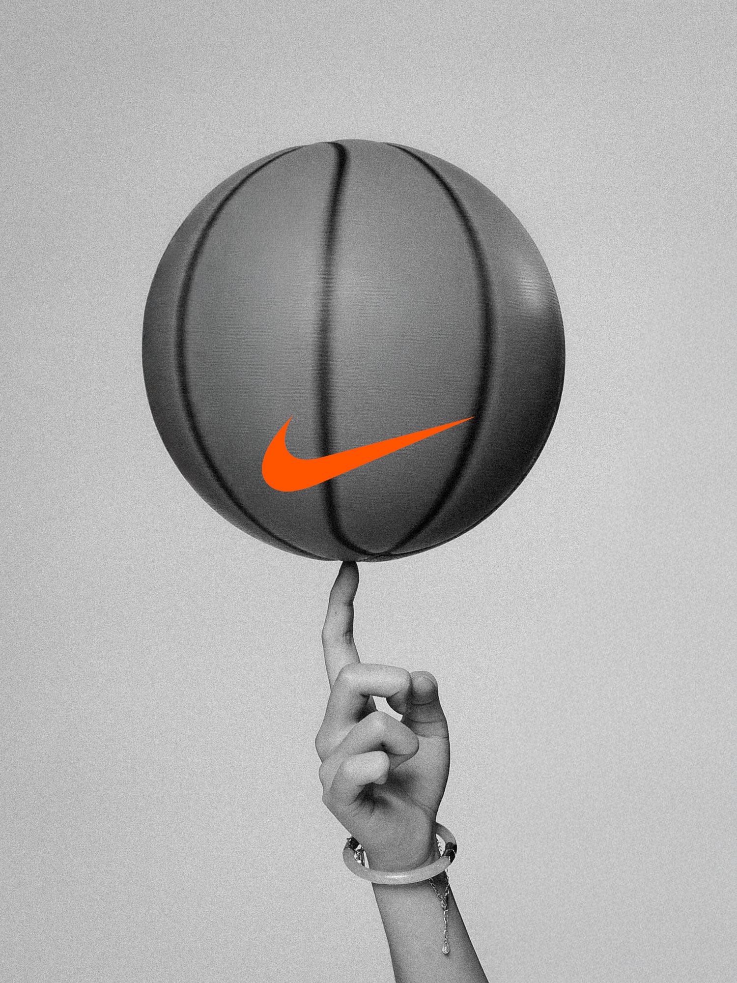 Series of hands spinning a Nike basketball against gray background showing orange swoosh logo.