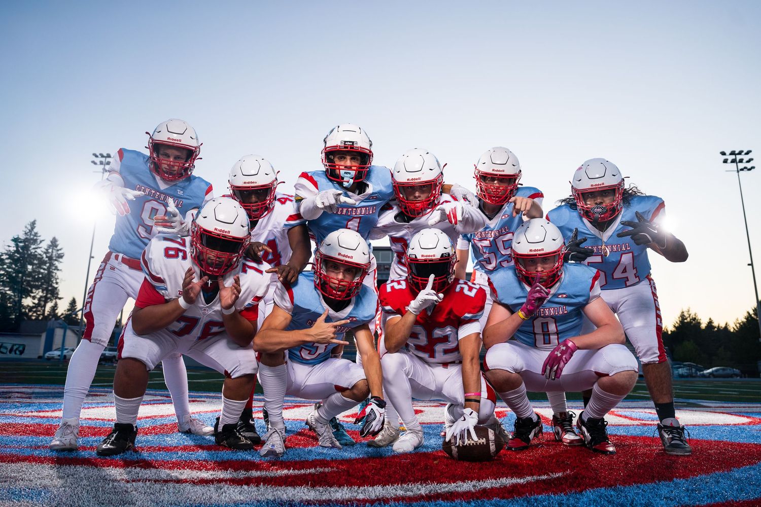 Football team lined up in formation on field during practice or game.