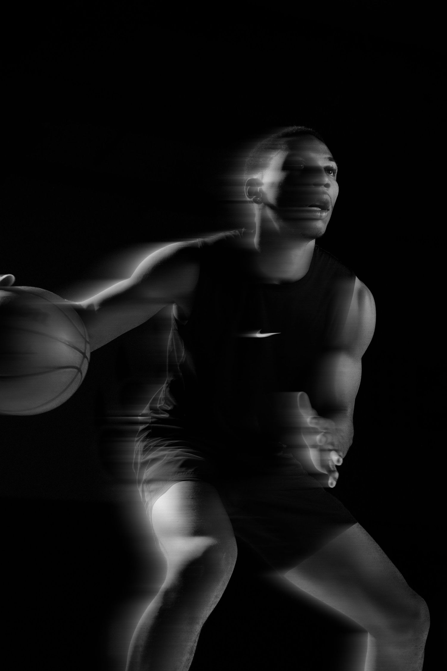 Motion blur capture of basketball player in Nike uniform making dynamic move.