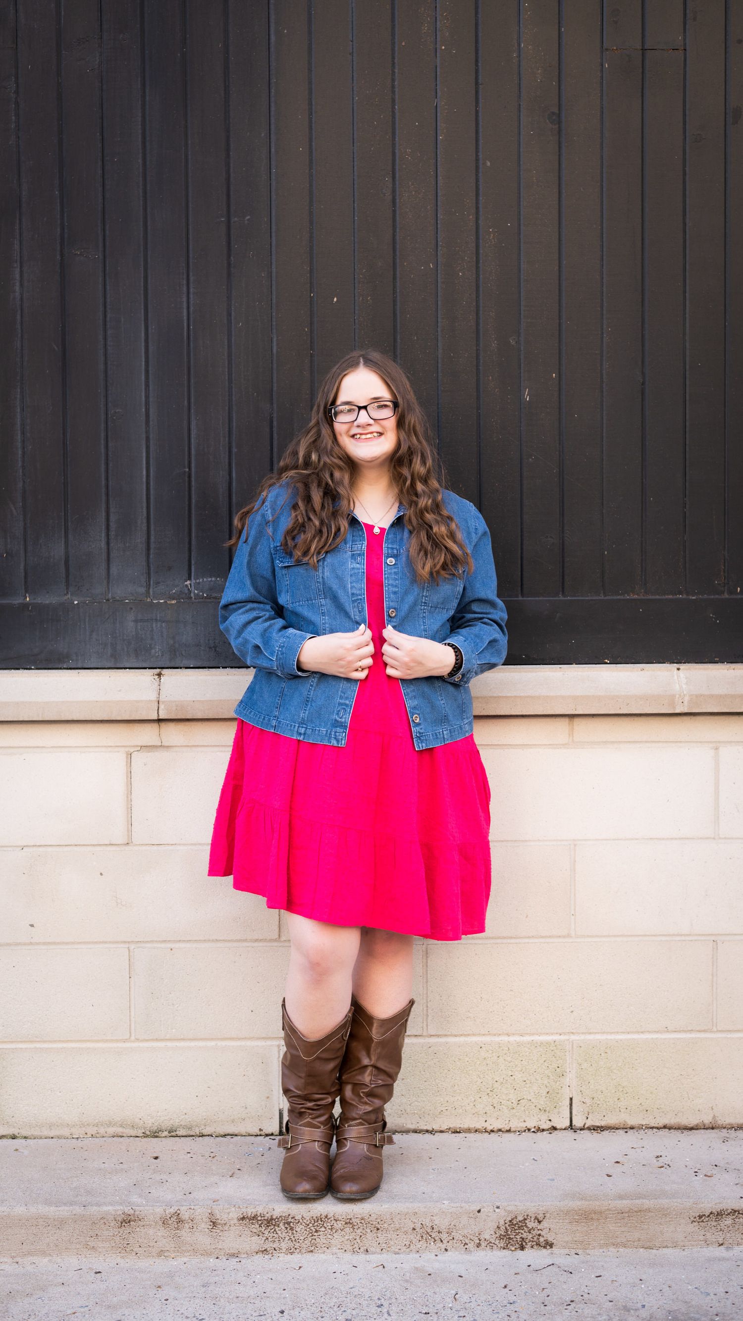 Fashion portraits against a dark wooden wall featuring denim jacket and red dress outfit combinations.