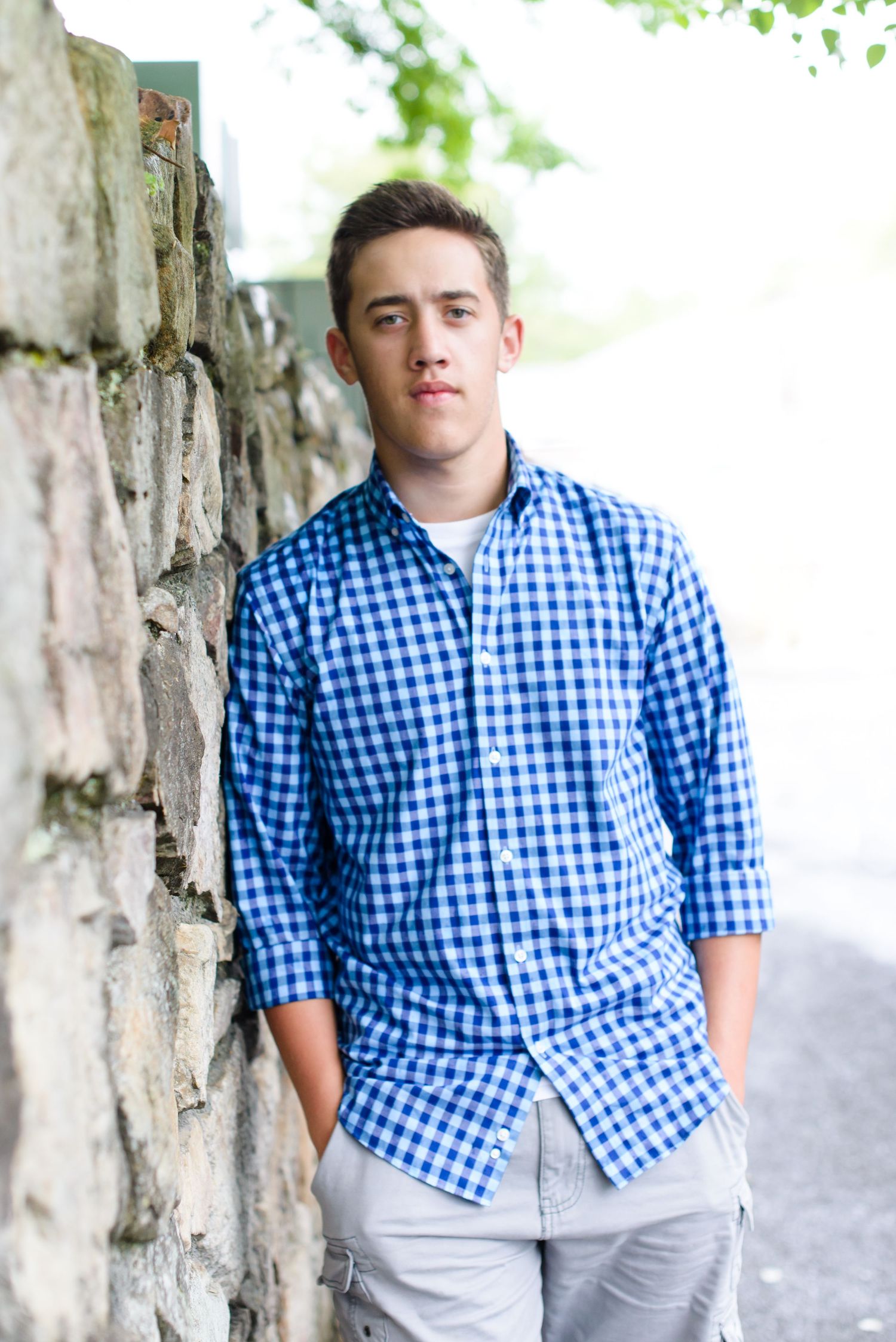 Series of casual portraits featuring blue gingham shirt against white textured background.