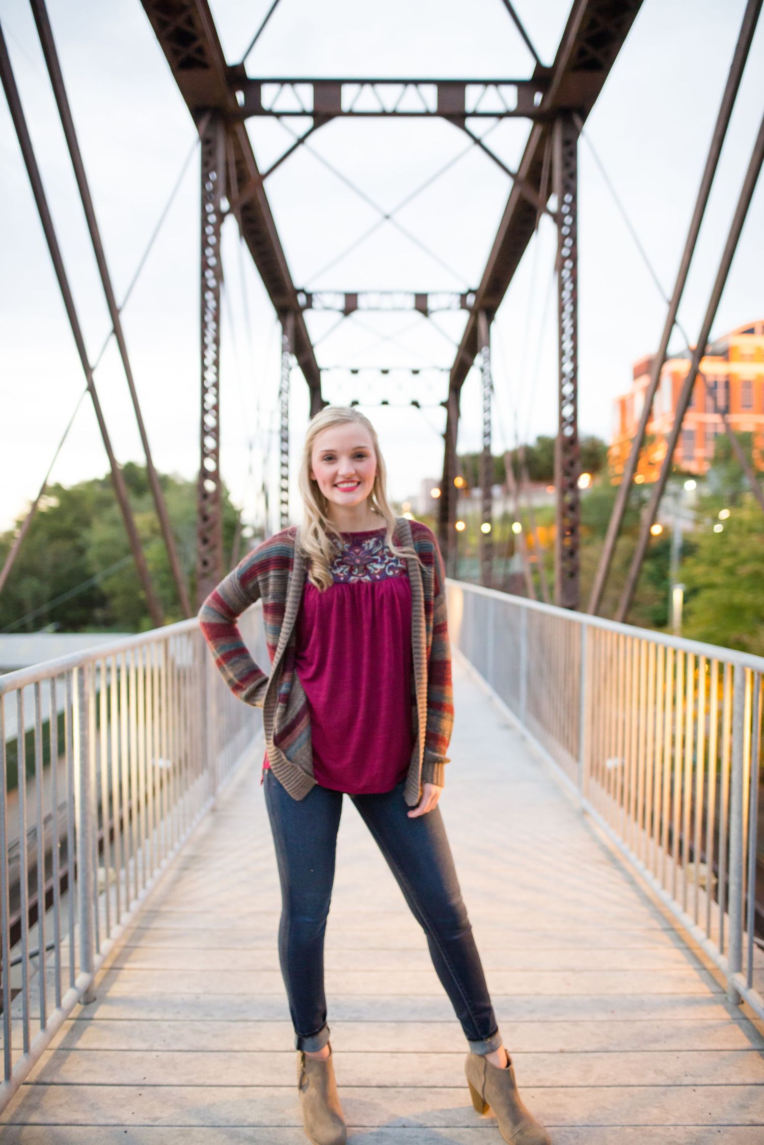 Series of photos showing a person in casual attire posing on a rustic metal bridge at sunset.