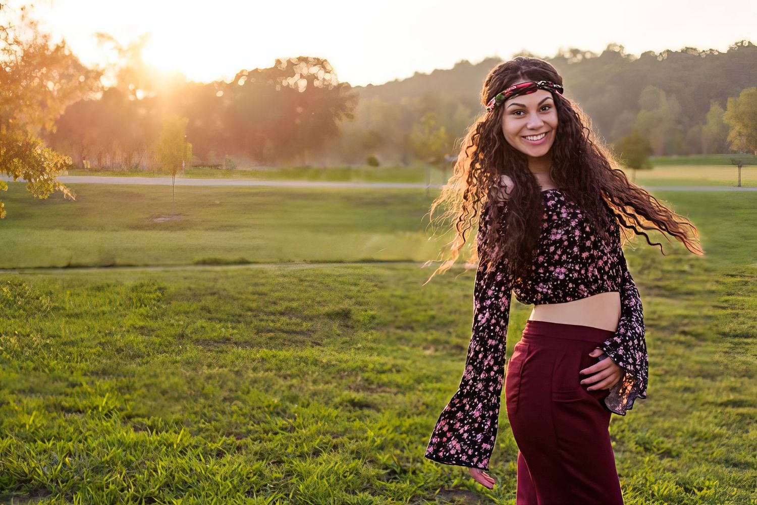 Sunset portrait session in open field with flowing dress and natural golden lighting.